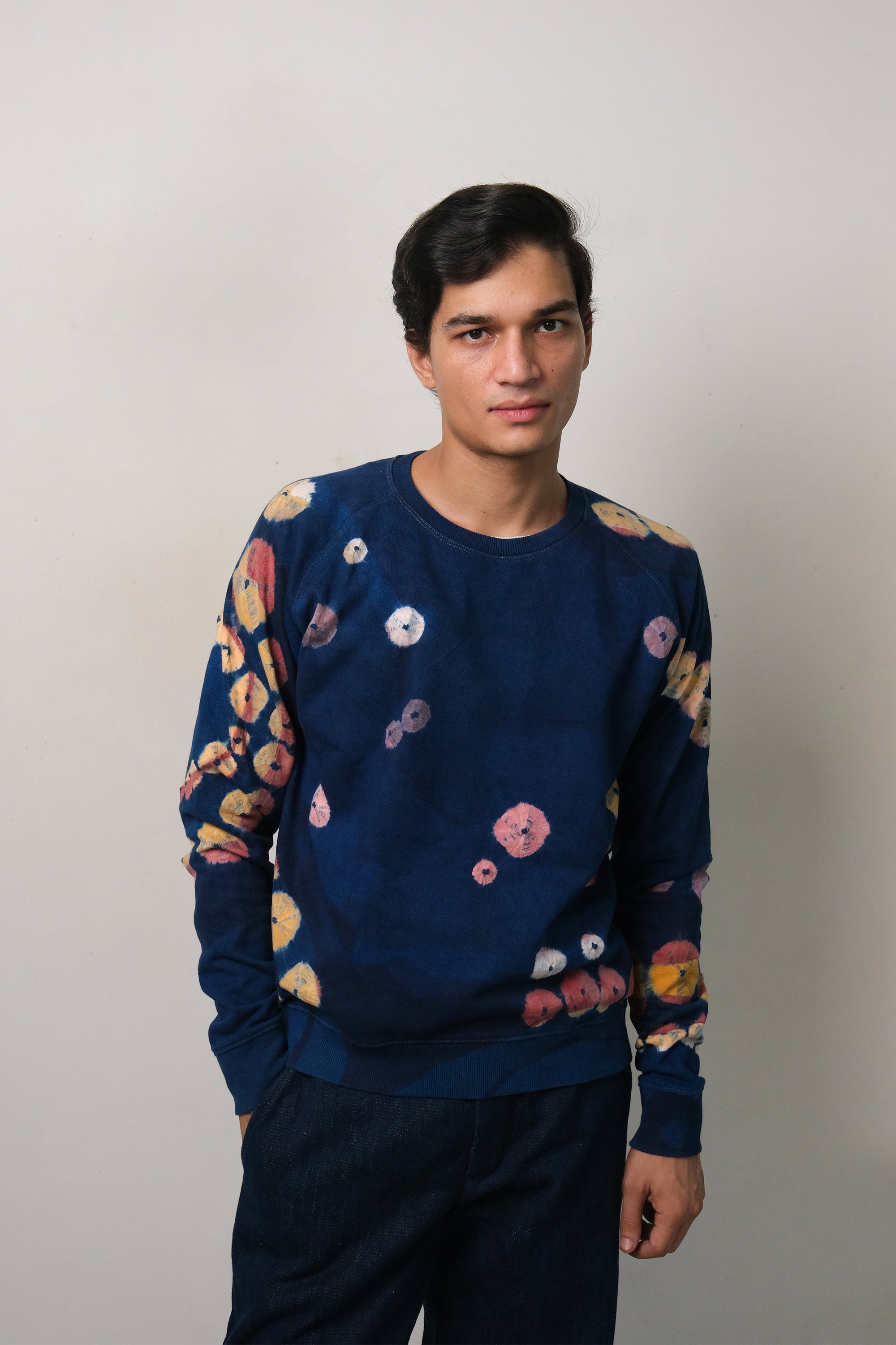 A man wearing of medium indigo handpaint bandhani sweatshirt
