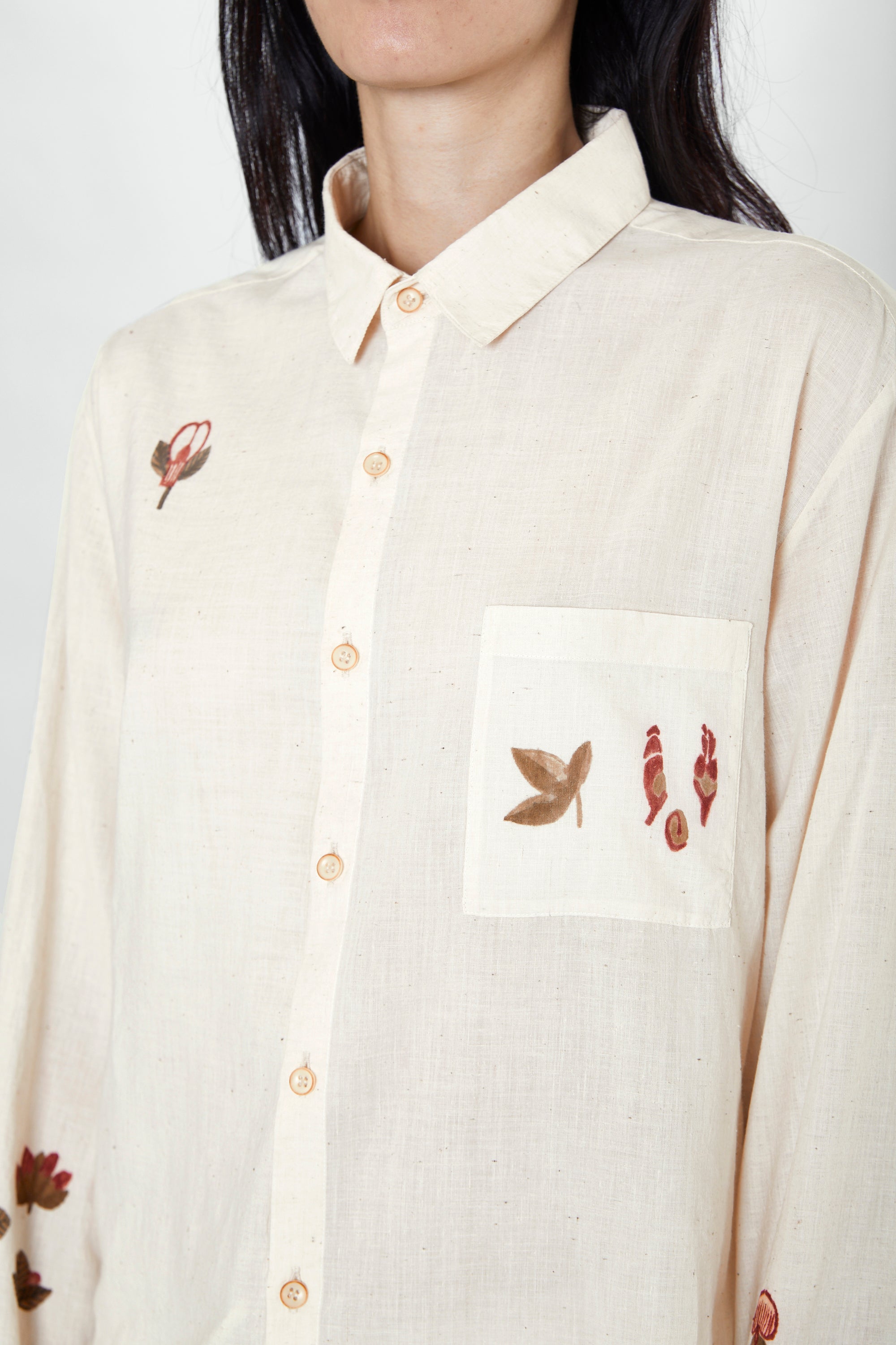 A woman wearing ecru shirt