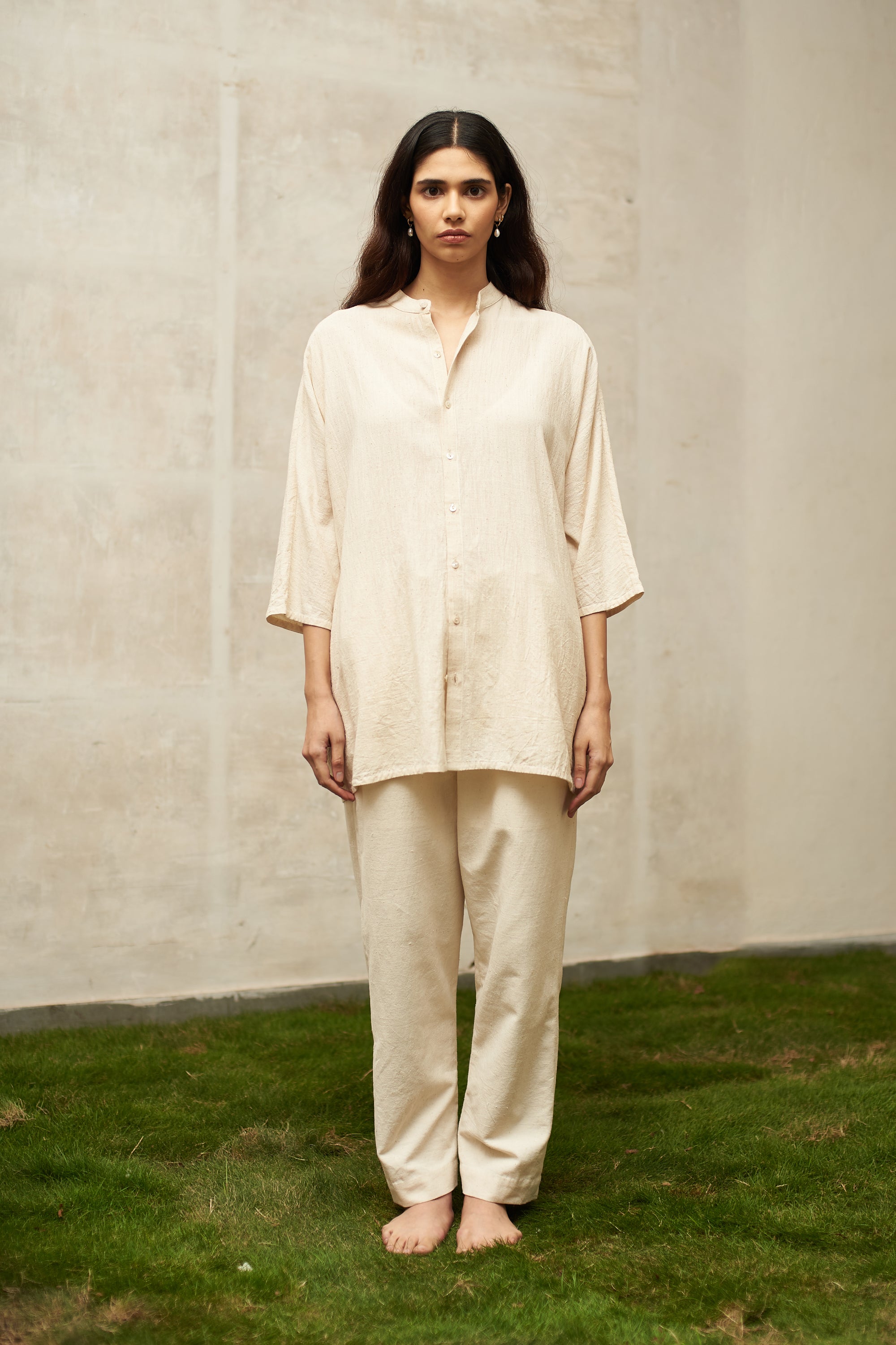 A woman wearing ecru shirt