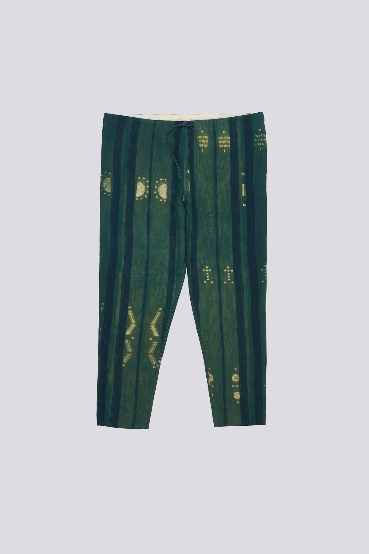 Bottle green pants with yellow patterns shibori a plain background