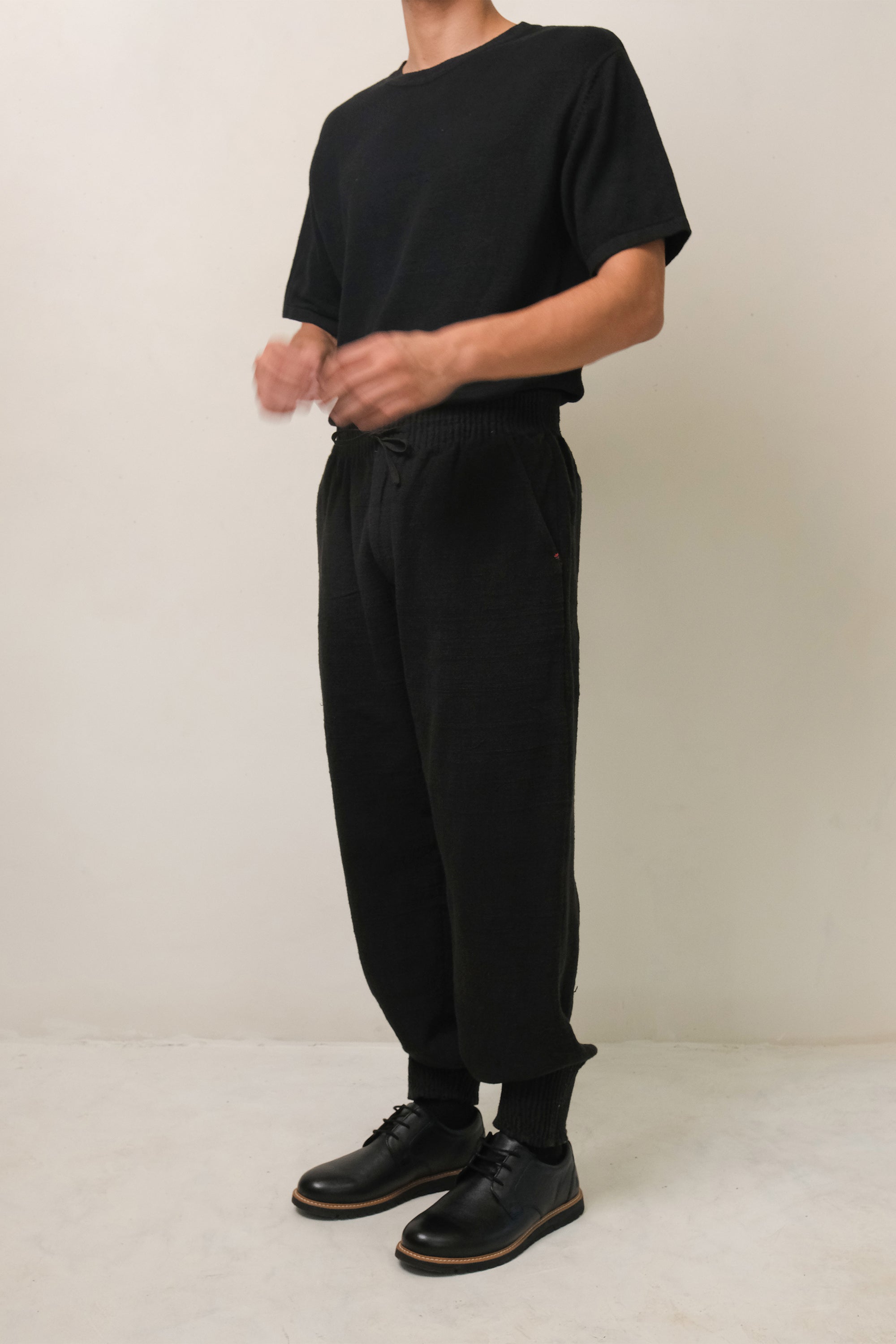 A man wearing black pant