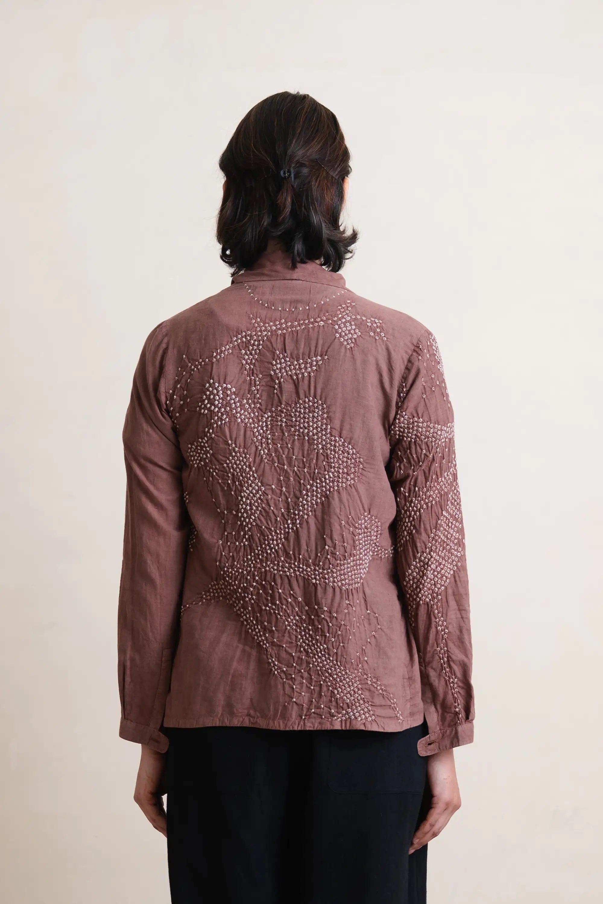 A back shot of woman wearing cotton old rose shrug