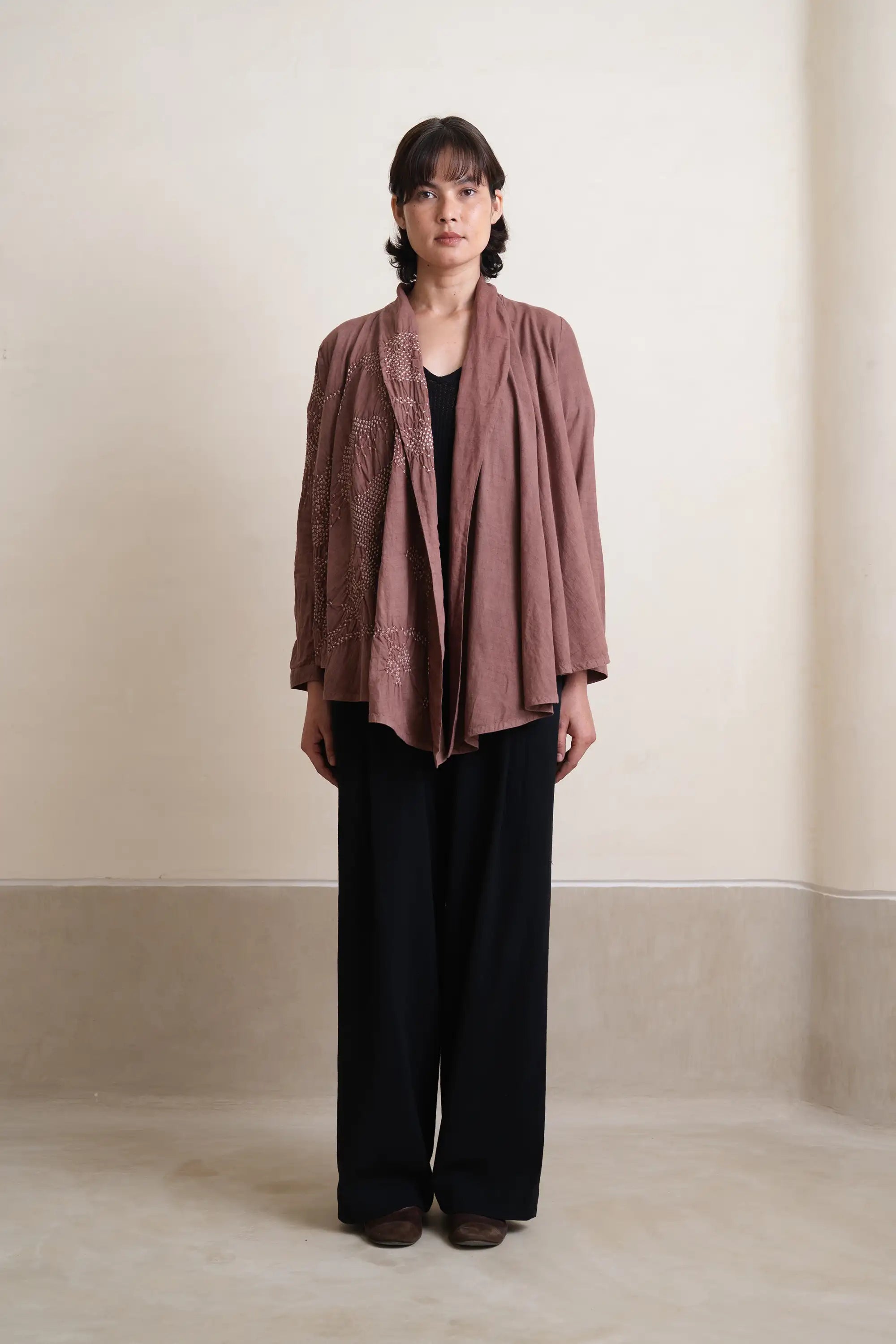 A woman wearing cotton old rose shrug