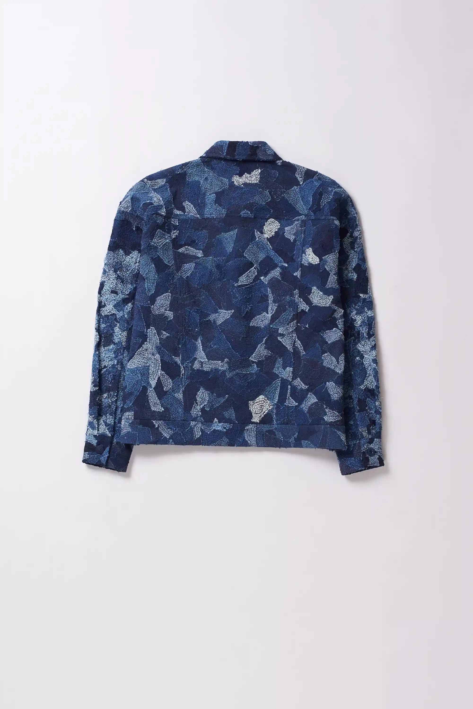 A back shot of a man wearing indigo denim jacket