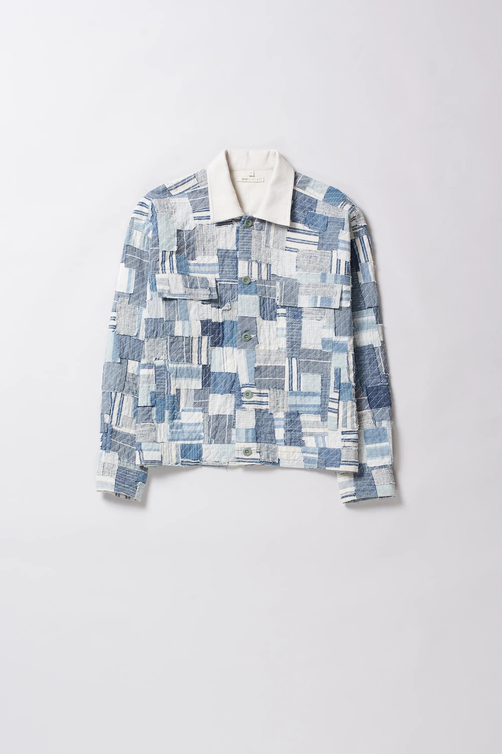 Patchwork patterned shirt on a light gray background