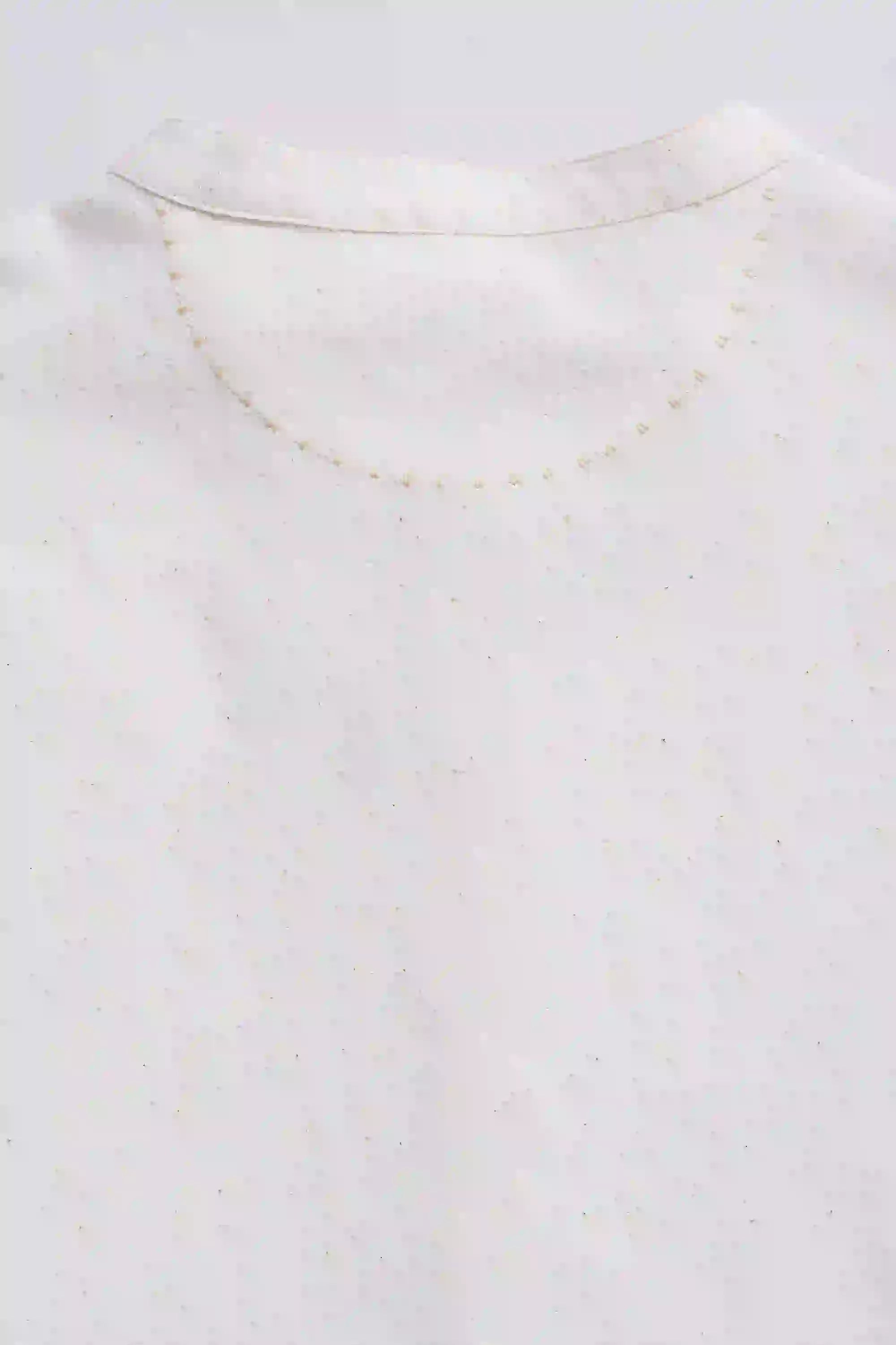 Close-up of a gold necklace on a grey background