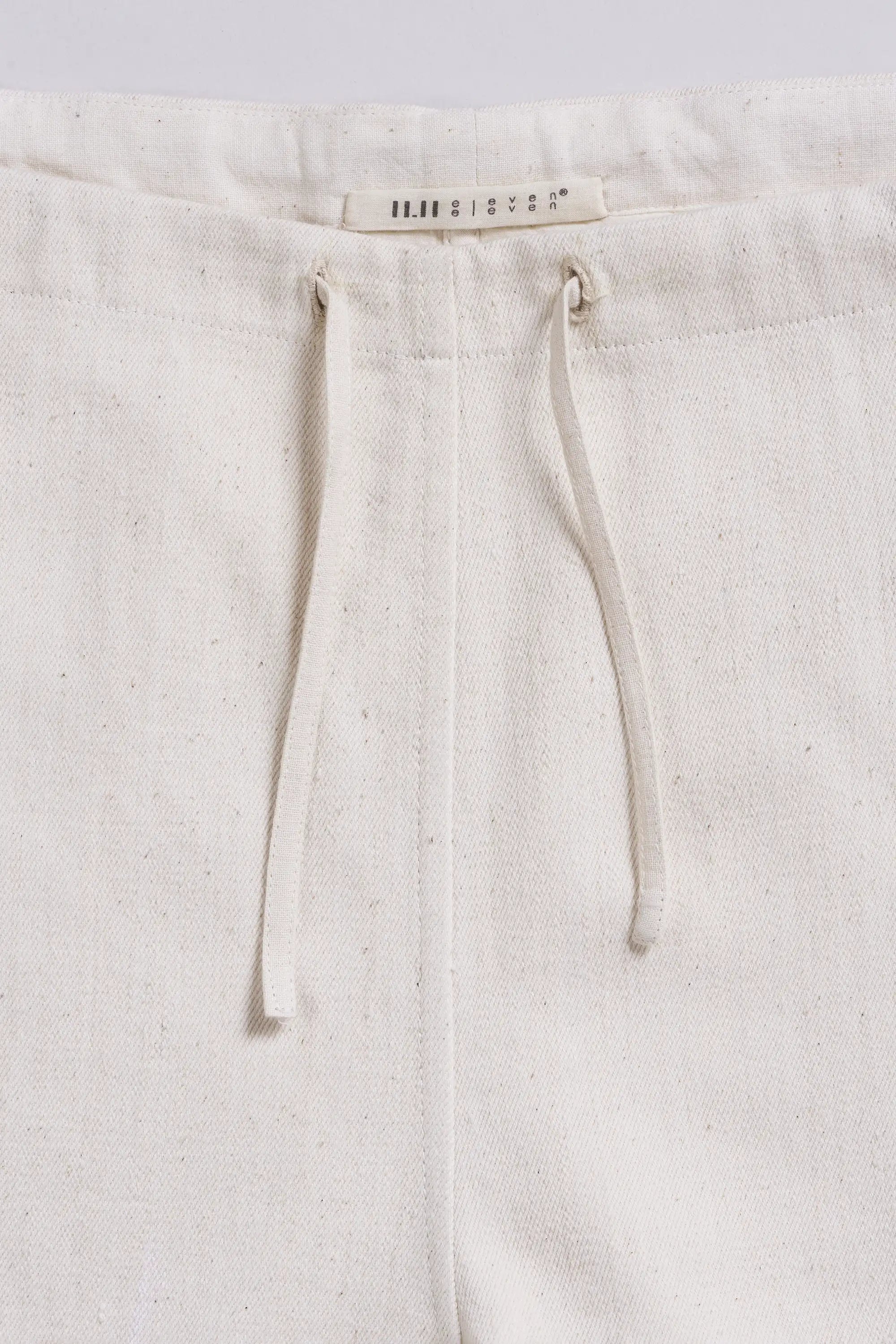 Close-up of pants with drawstring on a light grey background