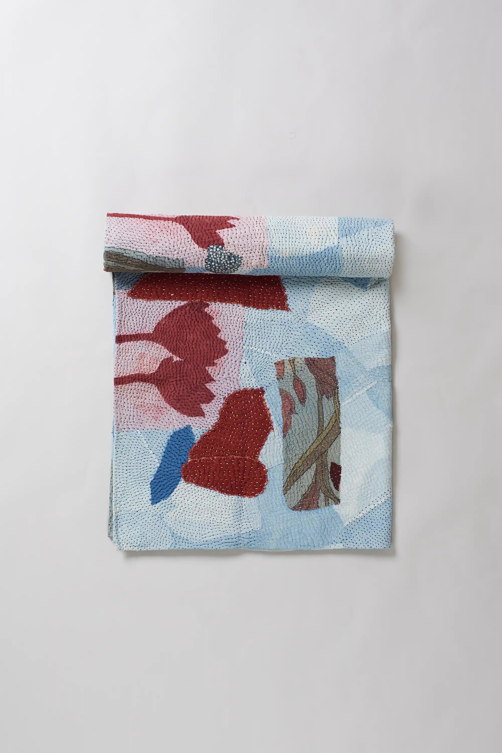 Indigo quilt roll on light grey background