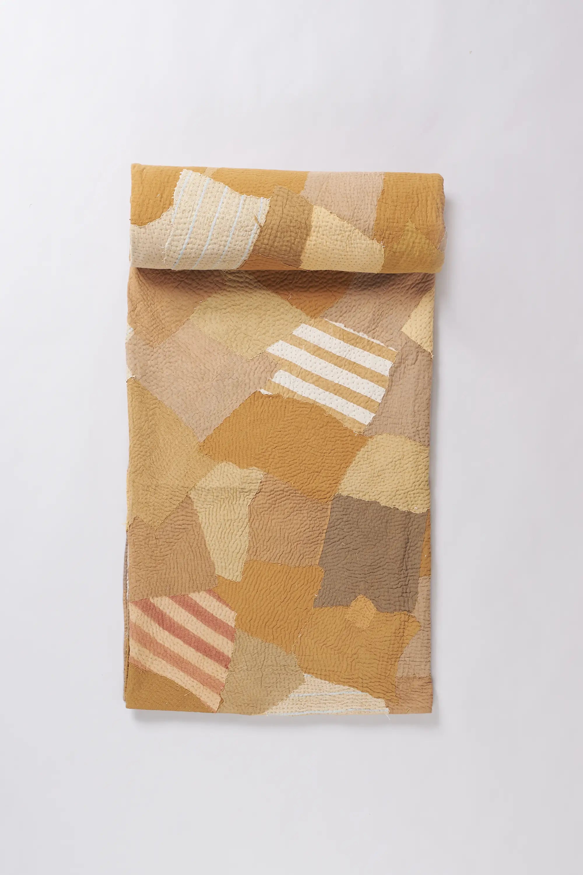 Colourfull quilt roll on a light grey background