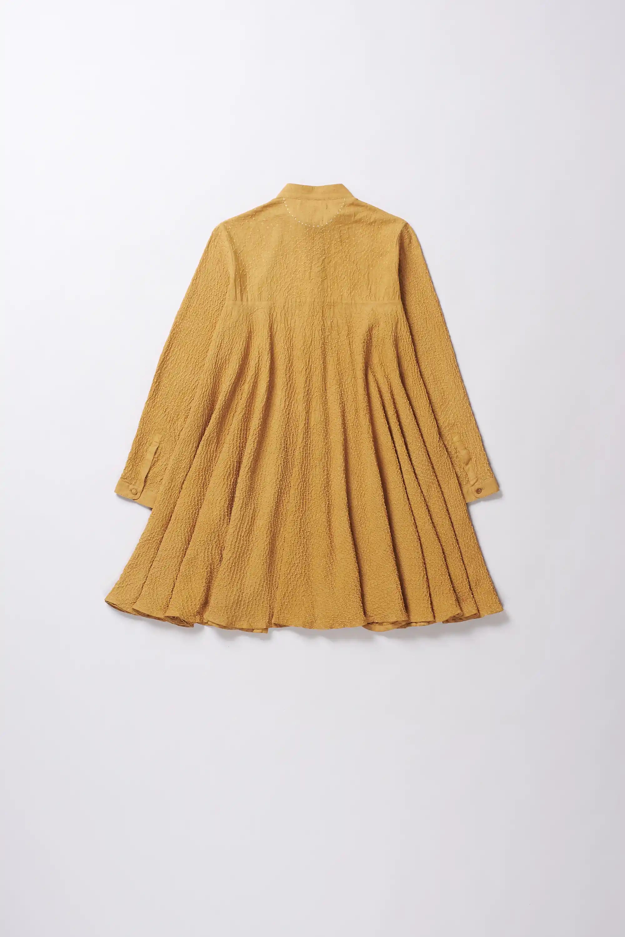 Mustard yellow pleated dress on a white background