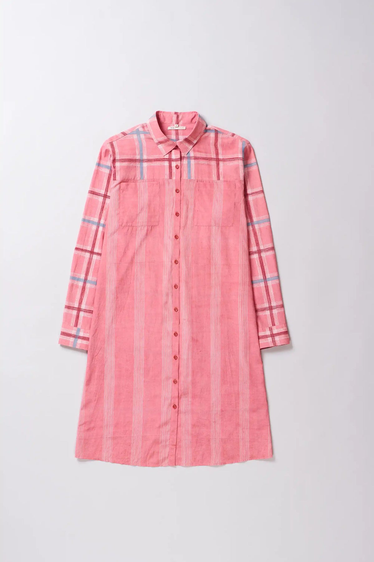 Pink plaid shirt dress on a light gray background