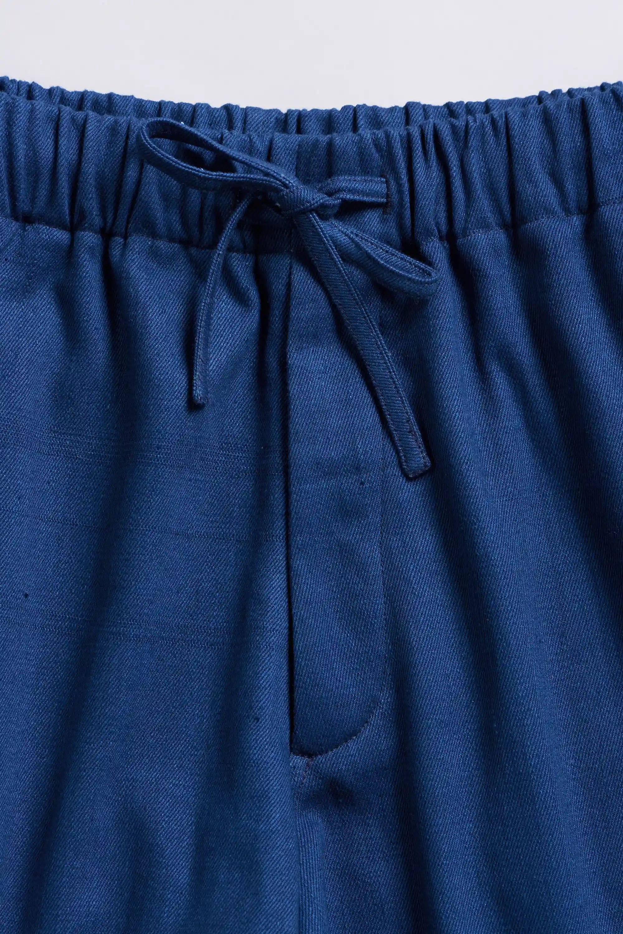 Fabric close-up with drawstring on a light grey background
