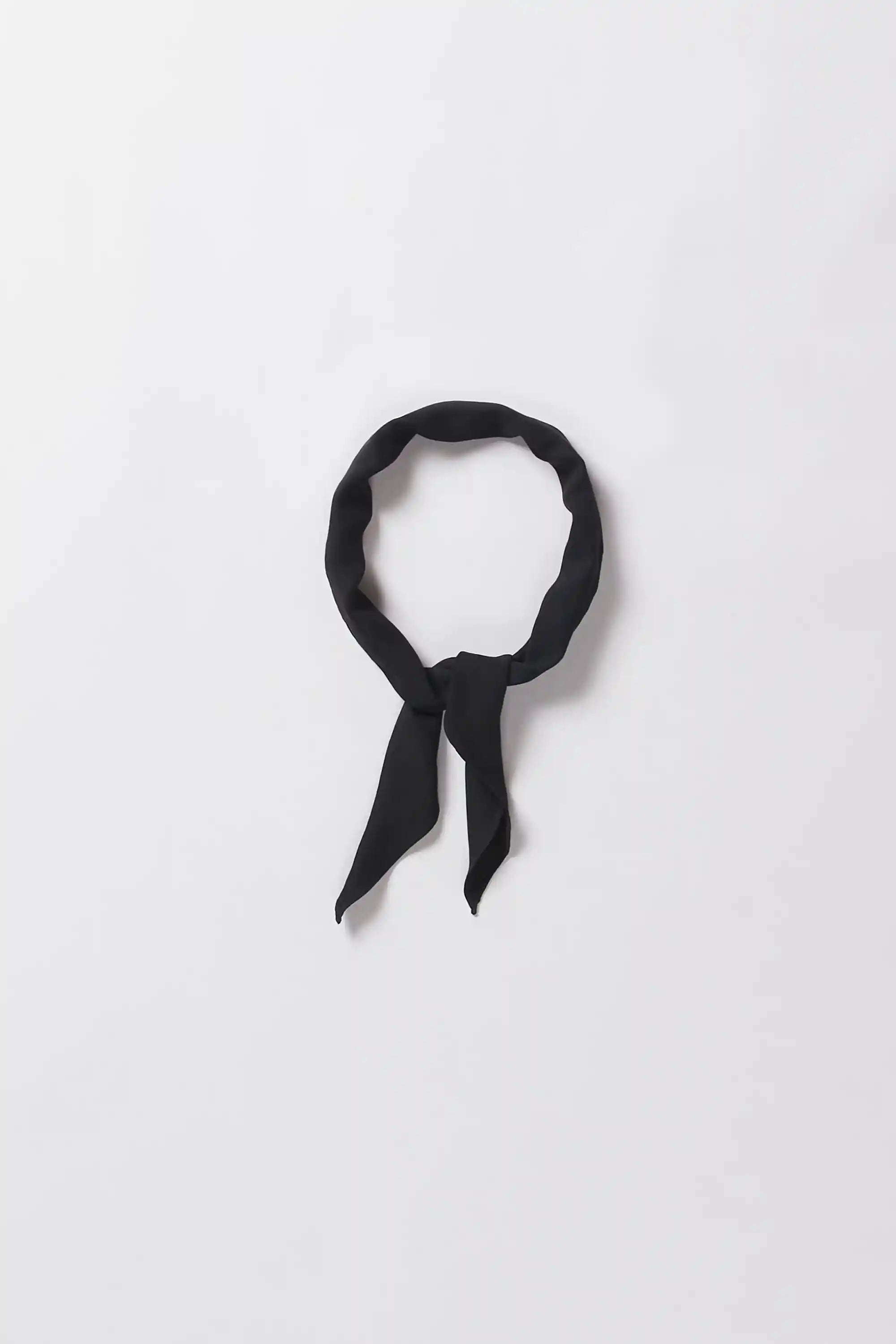 Black cotton bandana on a light grey background