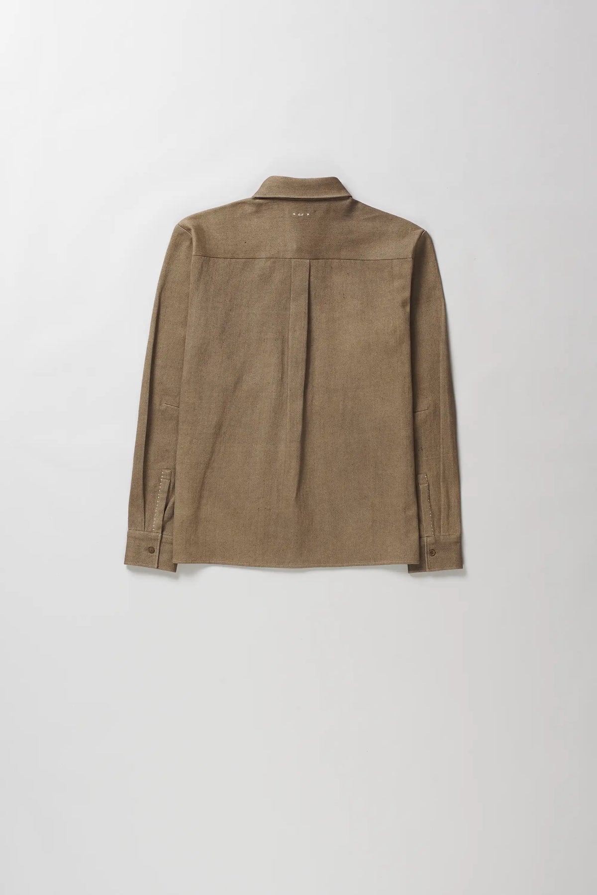 A light brown long-sleeve button-up shirt with a subtle vertical pleat detail on the back, laid flat against a light grey background.