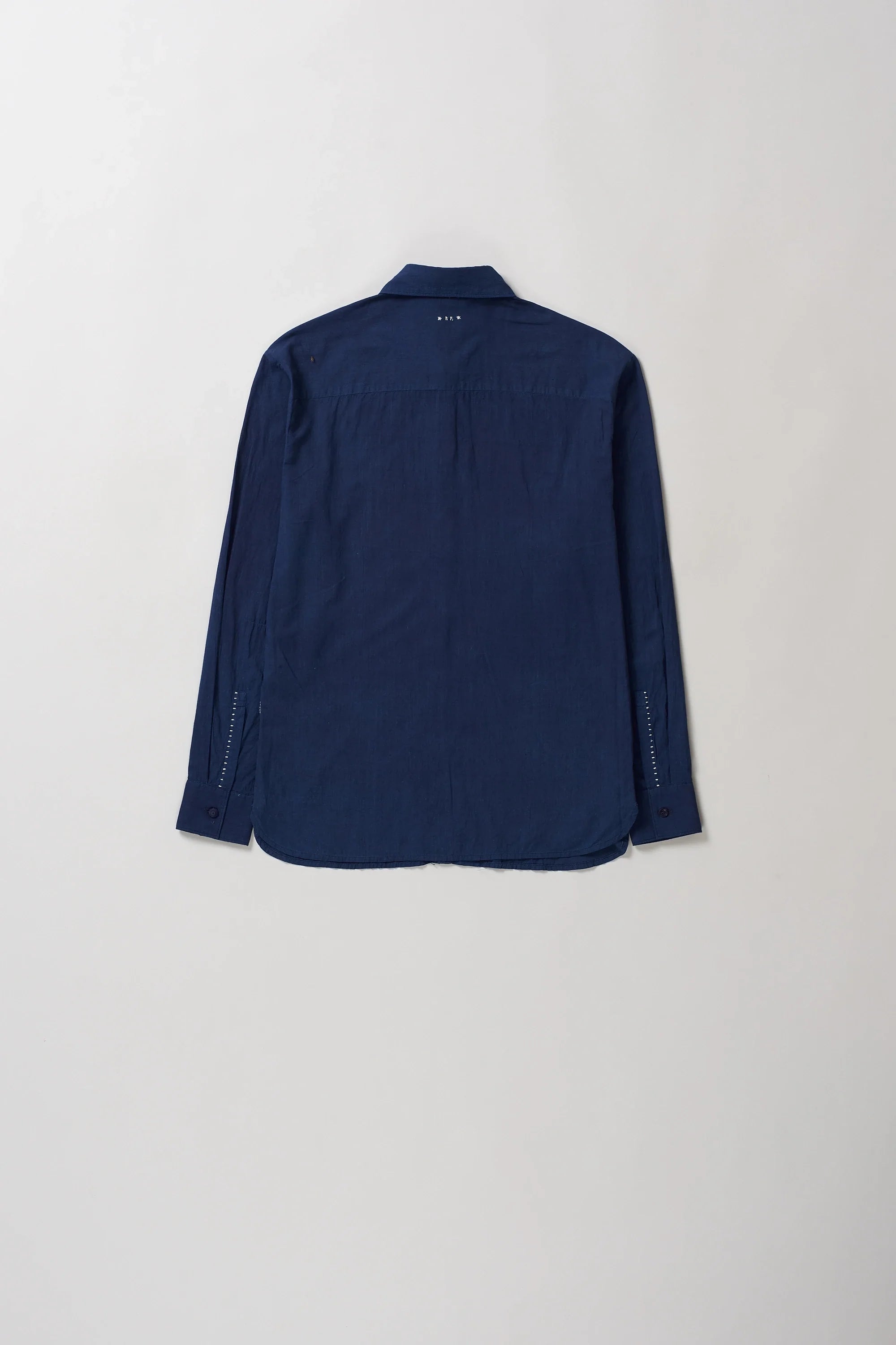Back image of indigo cotton shirt on a grey background