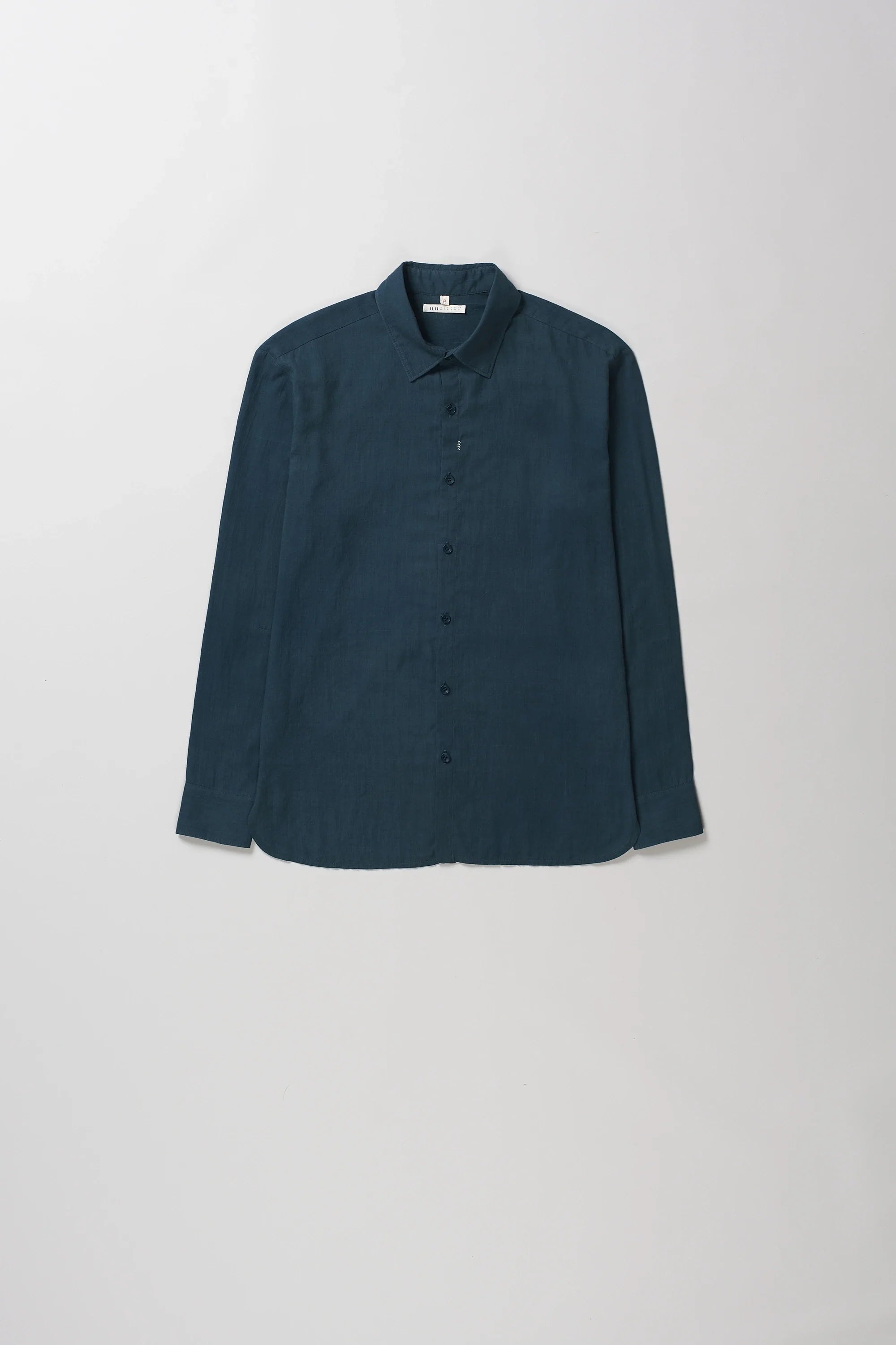 Black indigo long-sleeve button-up shirt with a pointed collar, laid flat against a light gray background.