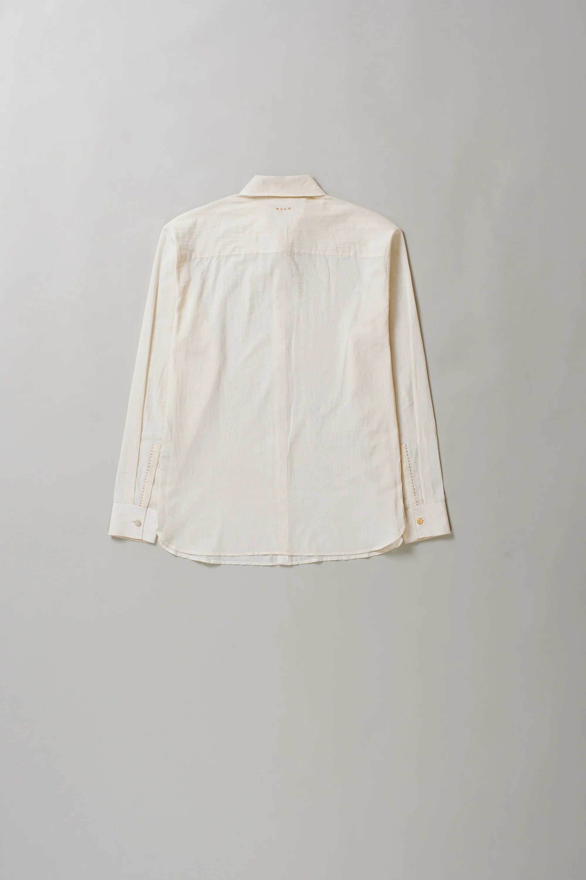 Back image of ecru cotton shirt on a grey background