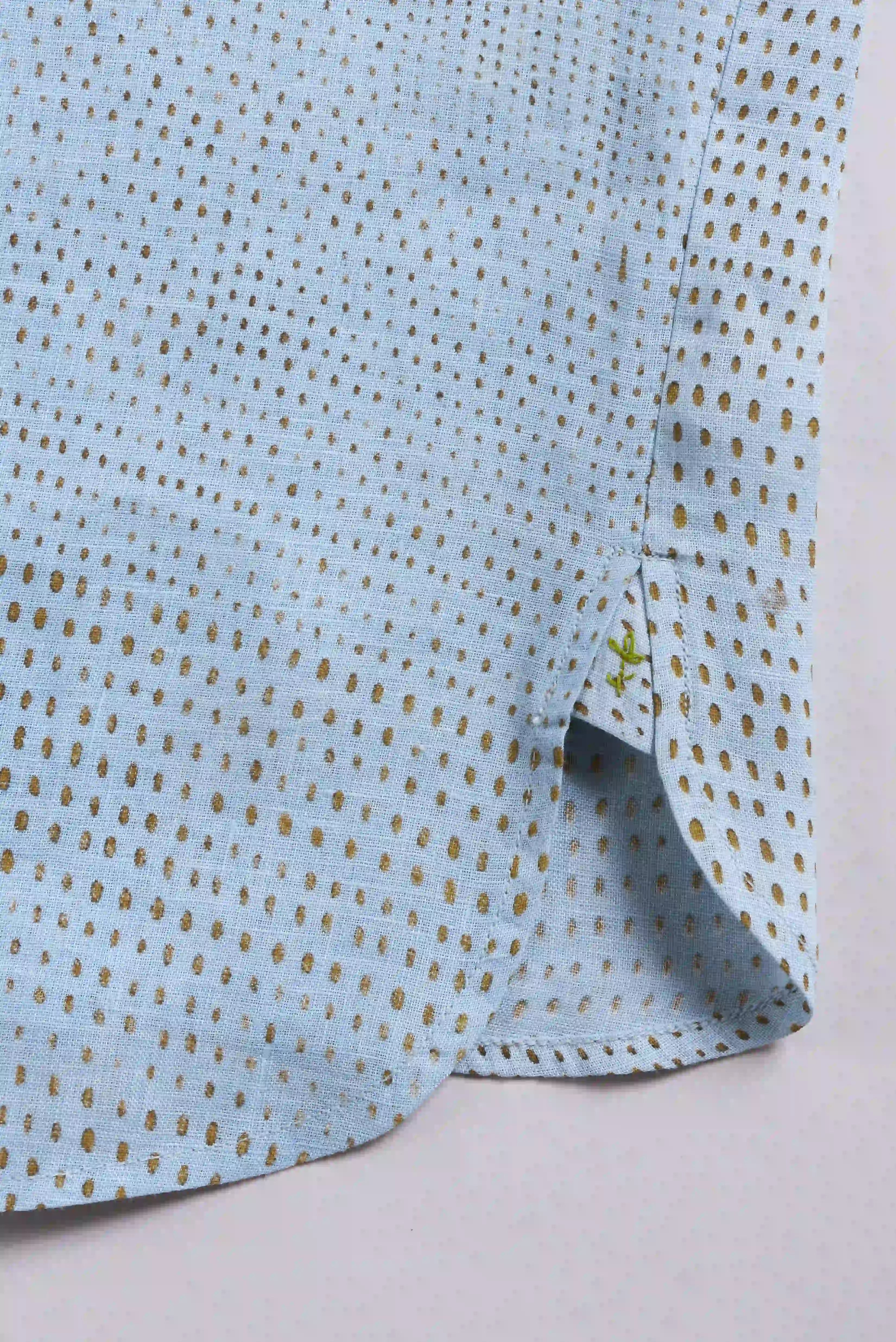 Close-up of a light blue fabric with small pehchan on a white background