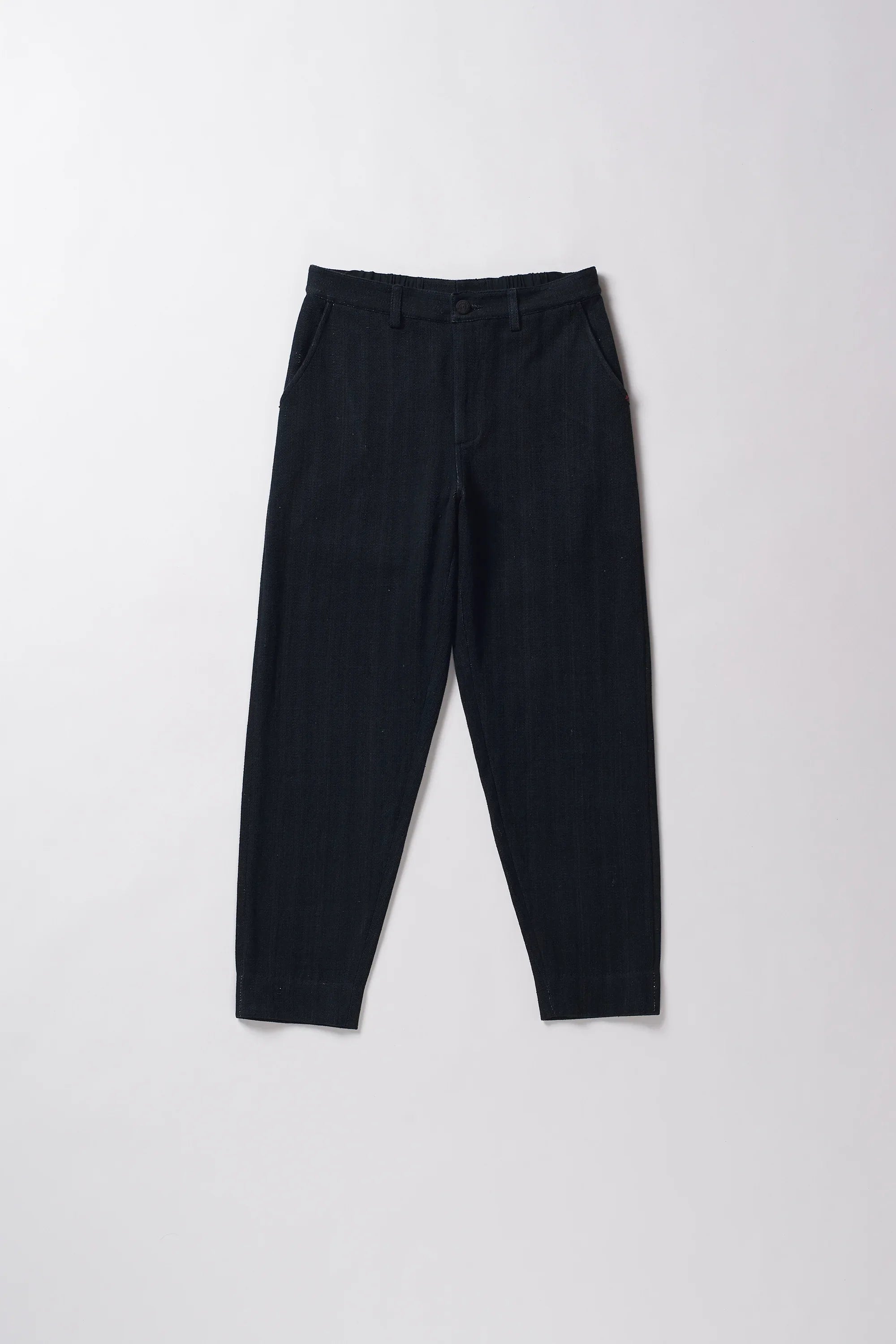Front image of midnight indigo pants on a grey background