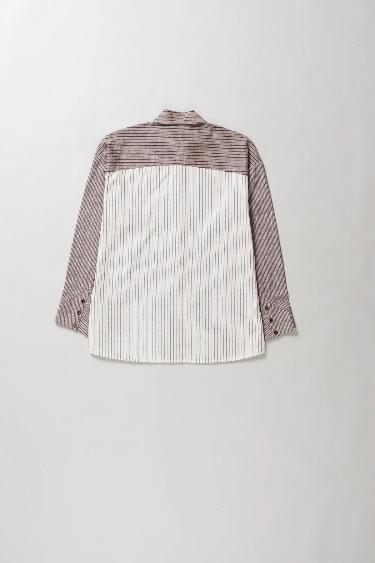 A long-sleeve button-up shirt shown from the back, featuring a color-blocked design with a white and brown vertical stripe pattern on the lower half, a solid brown upper yoke, and solid brown sleeves.