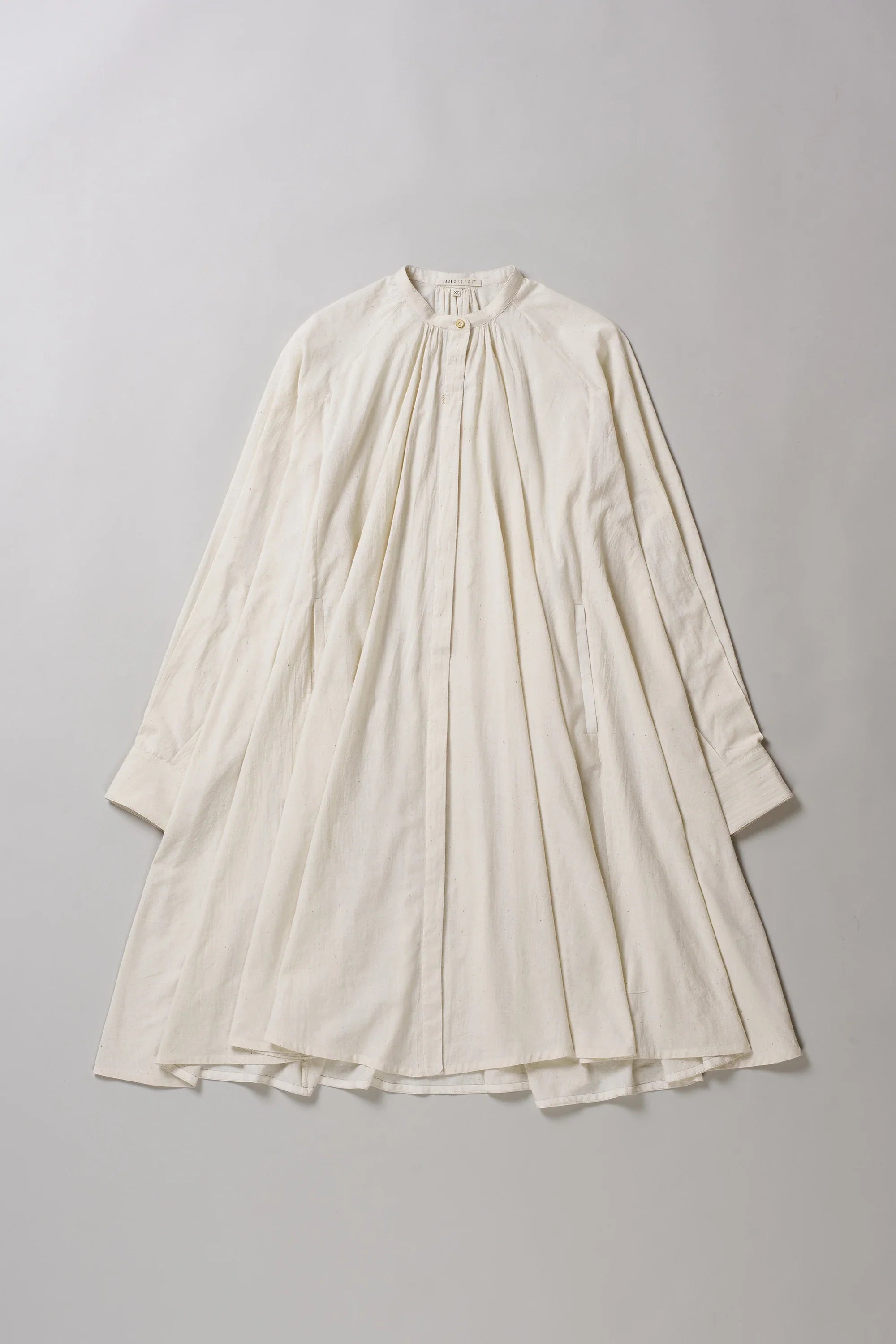 Front image of ecru dress on a grey background