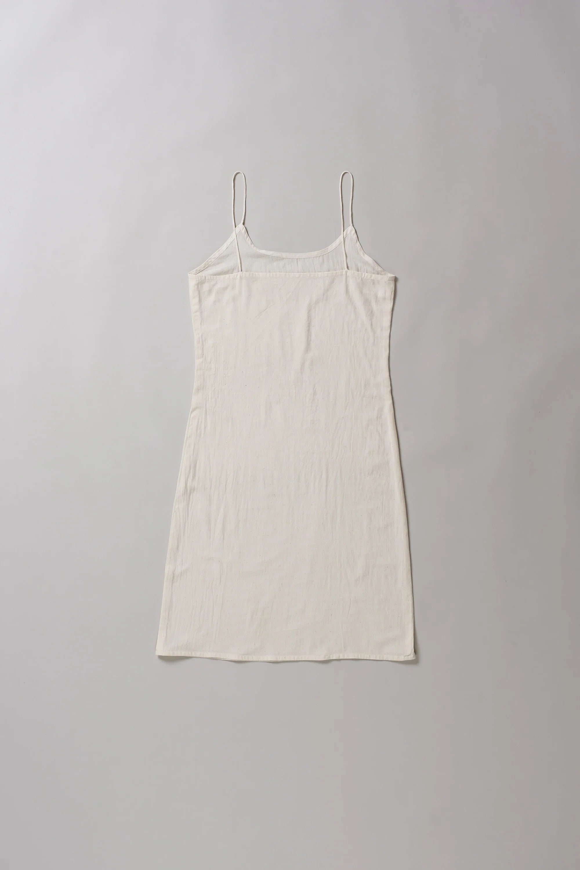 Back image of ecru slip dress on a grey background