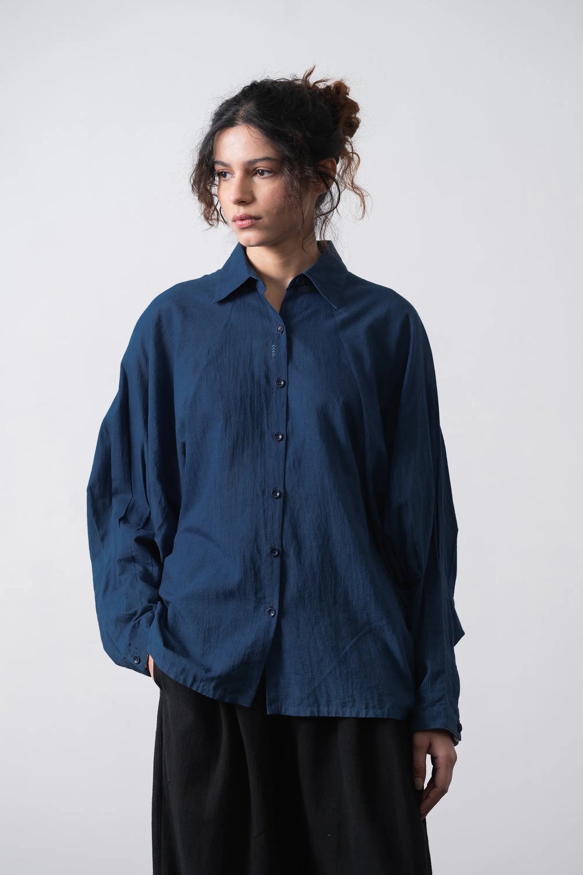 A woman wearing medium indigo shirt