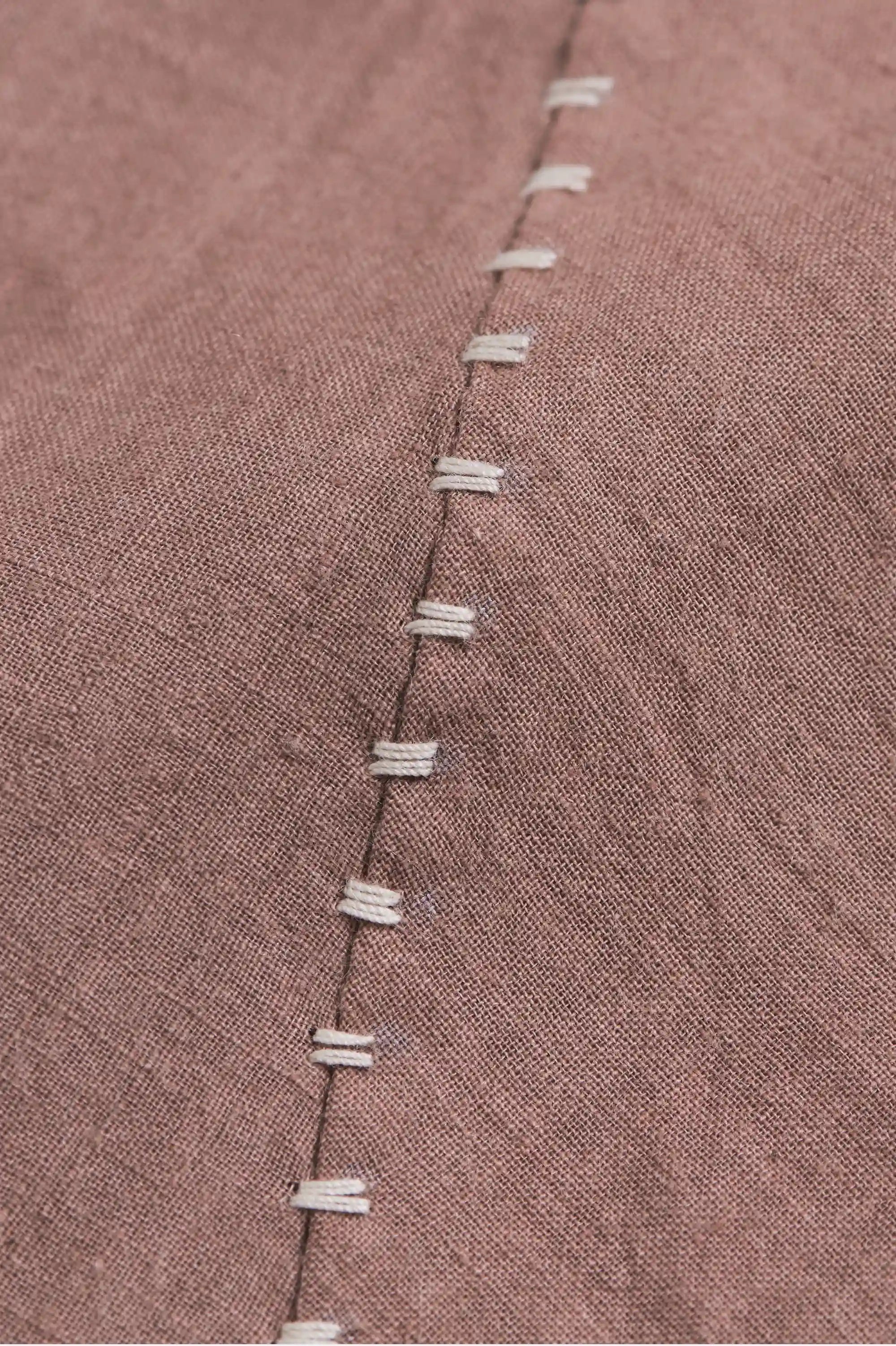 Close-up of a old rose fabric with a hand detailing