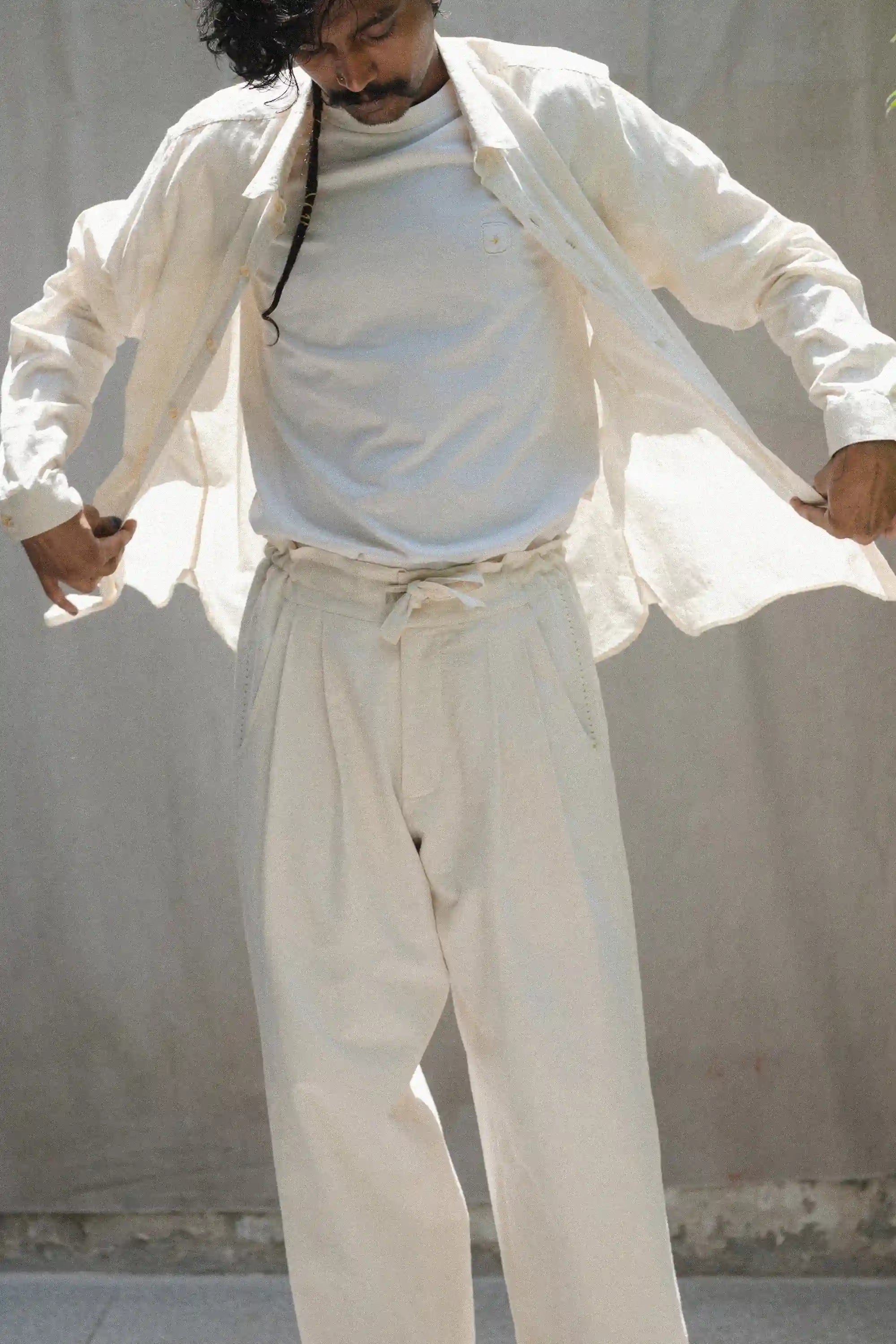 Person wearing a white outfit against a plain background