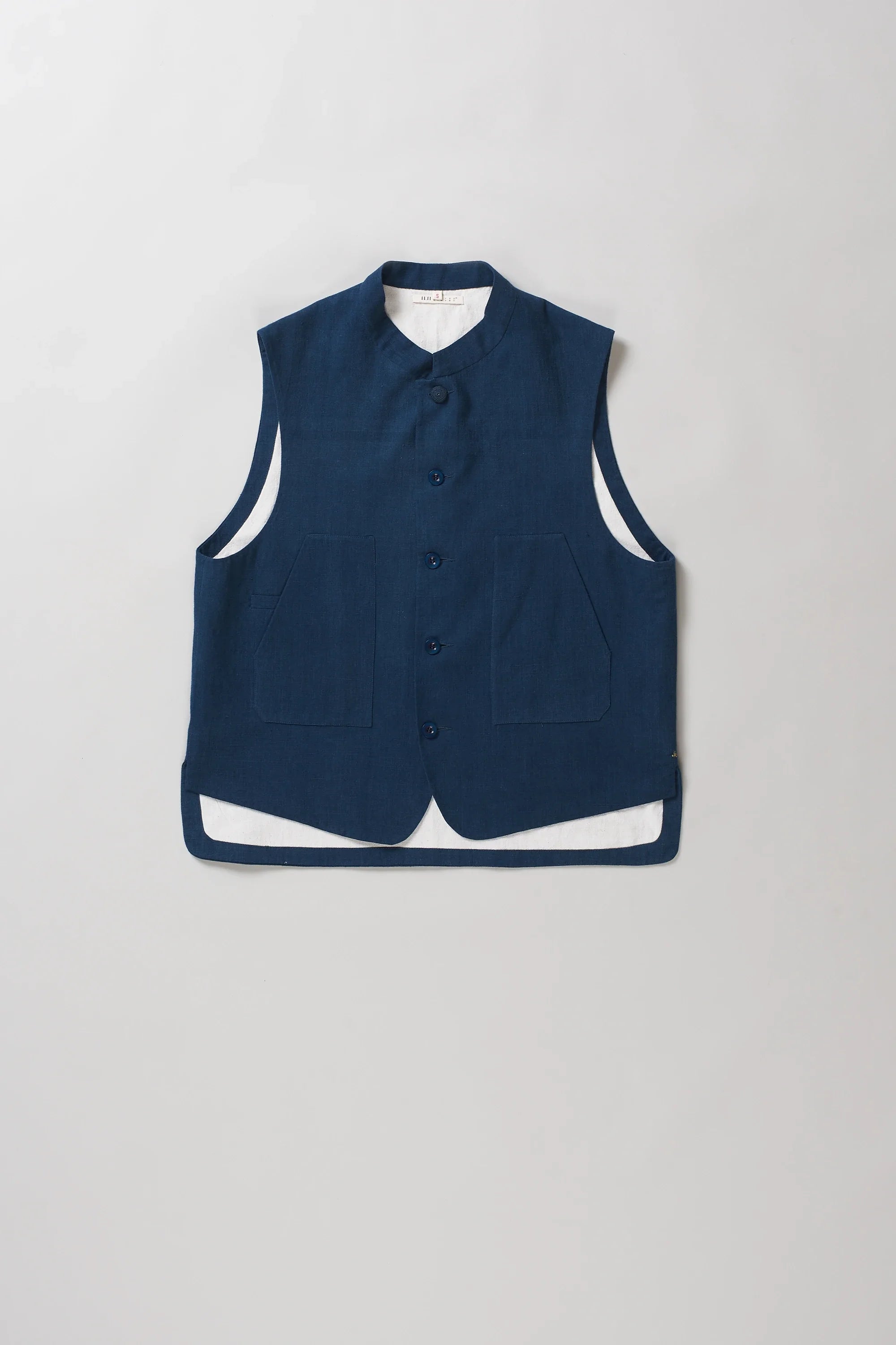 A sleeveless space blue vest with a mandarin collar and front button closure, 