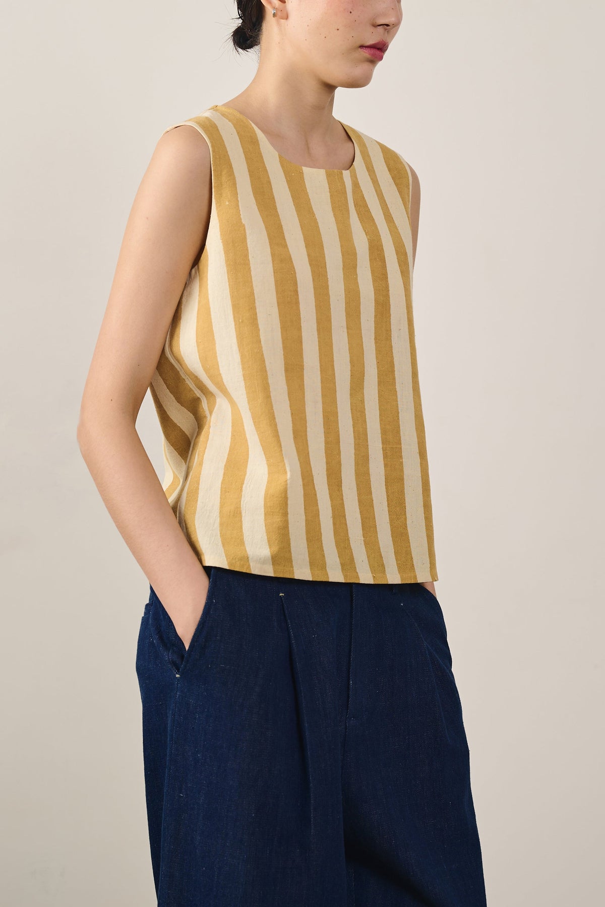A woman wearing mustard yellow top