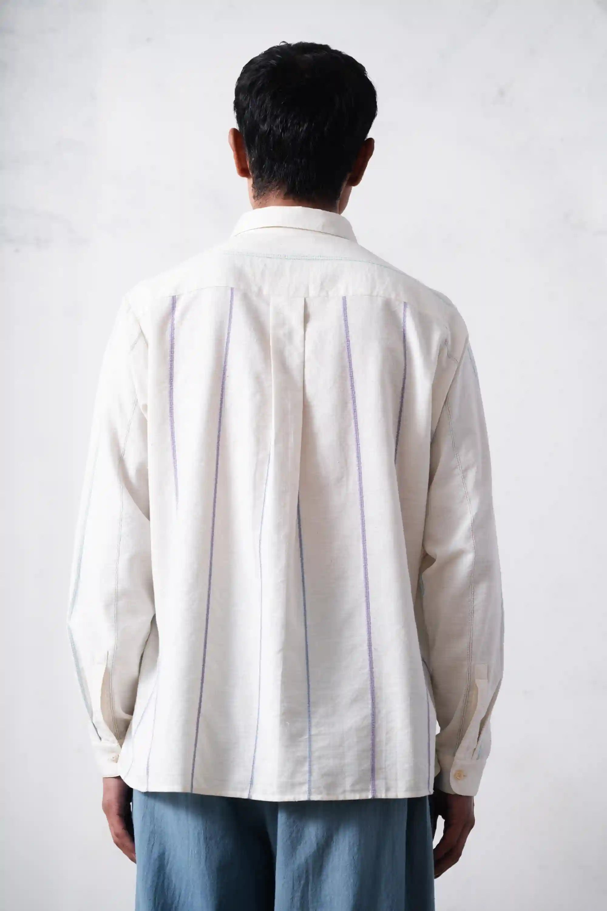 A back shot of men wearing ecru shirt