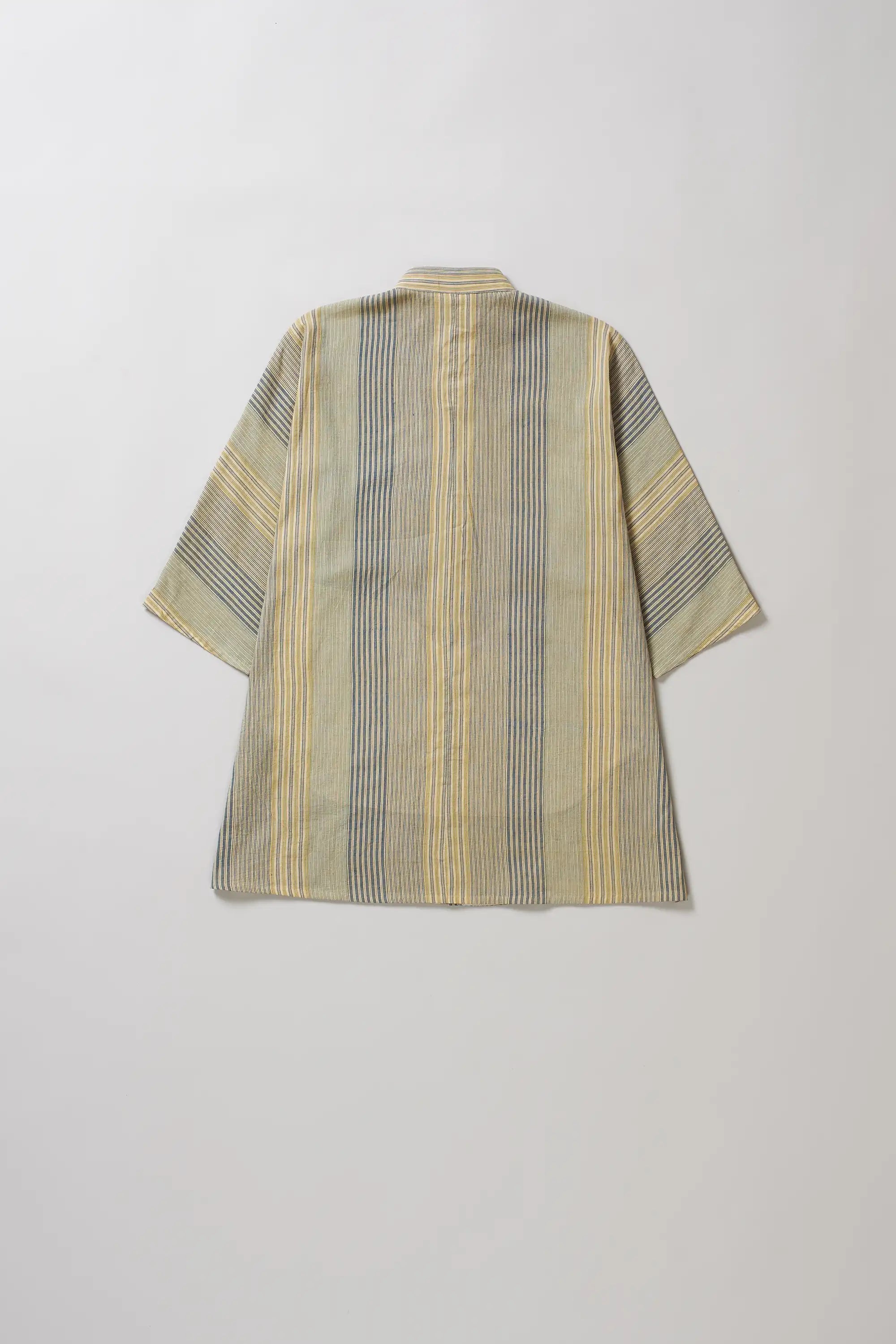 Striped shirt with a geometric pattern on a light grey background