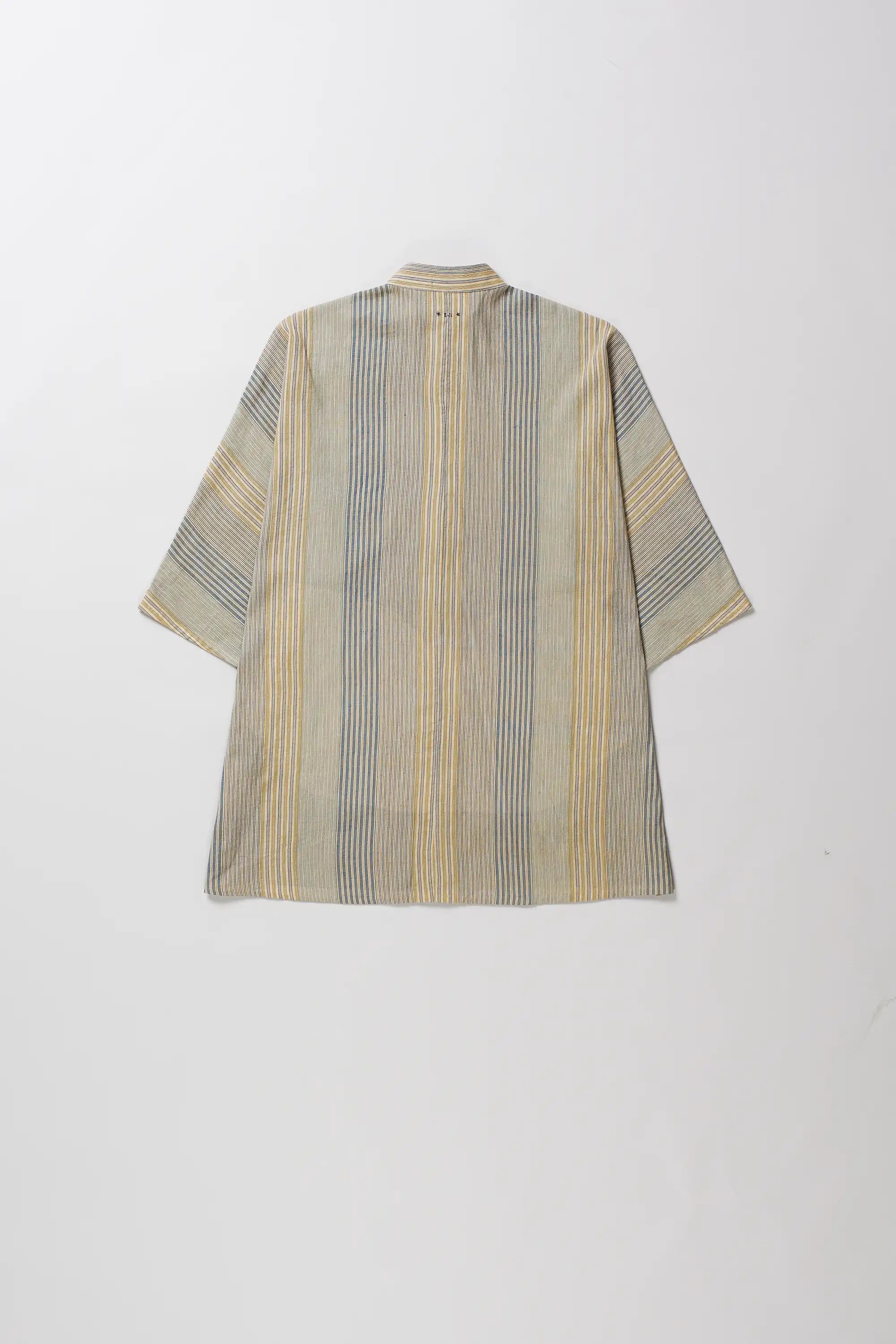 Back shot of short-sleeved button-up shirt with a vertical stripe pattern in beige, yellow, and grey, displayed flat against a light grey background.