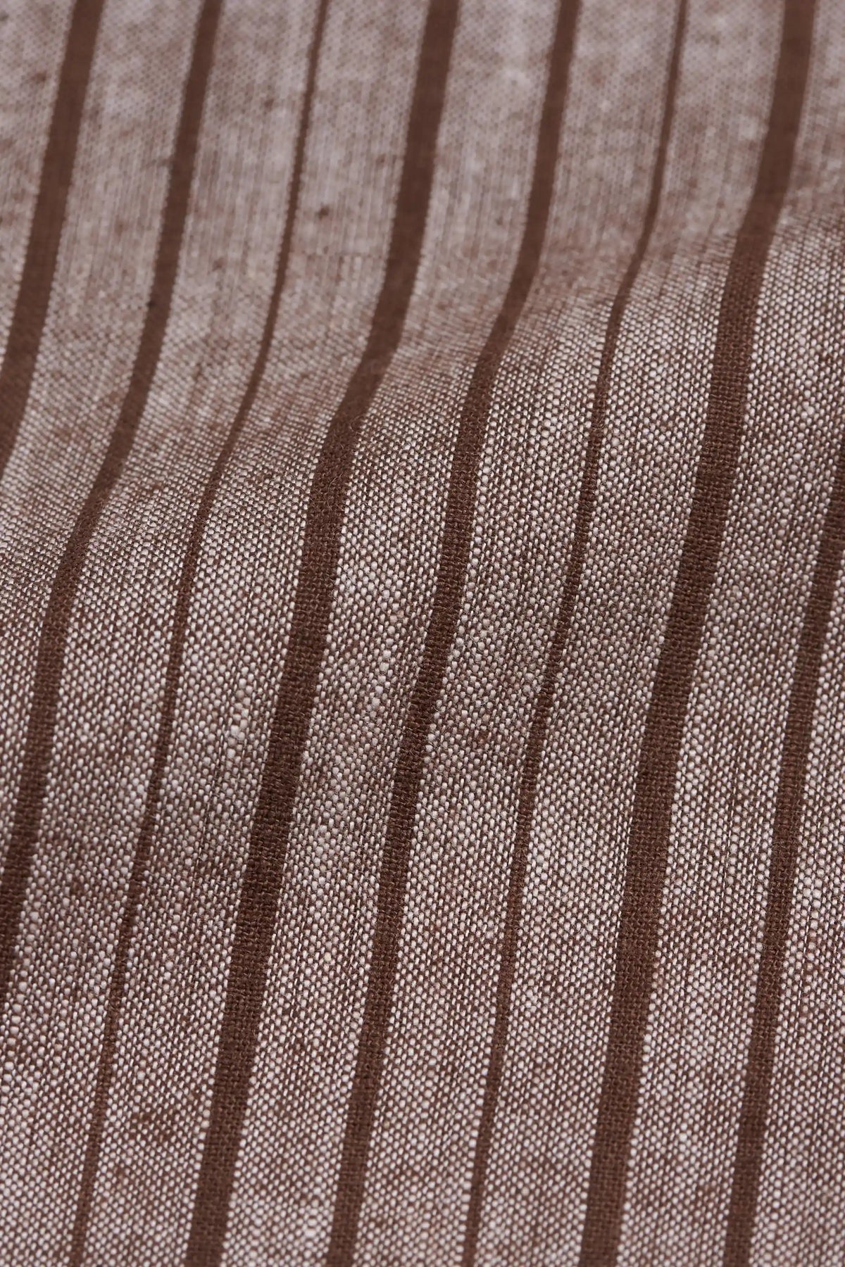 A close-up of a woven fabric with a warm taupe-beige base and vertical dark brown stripes.