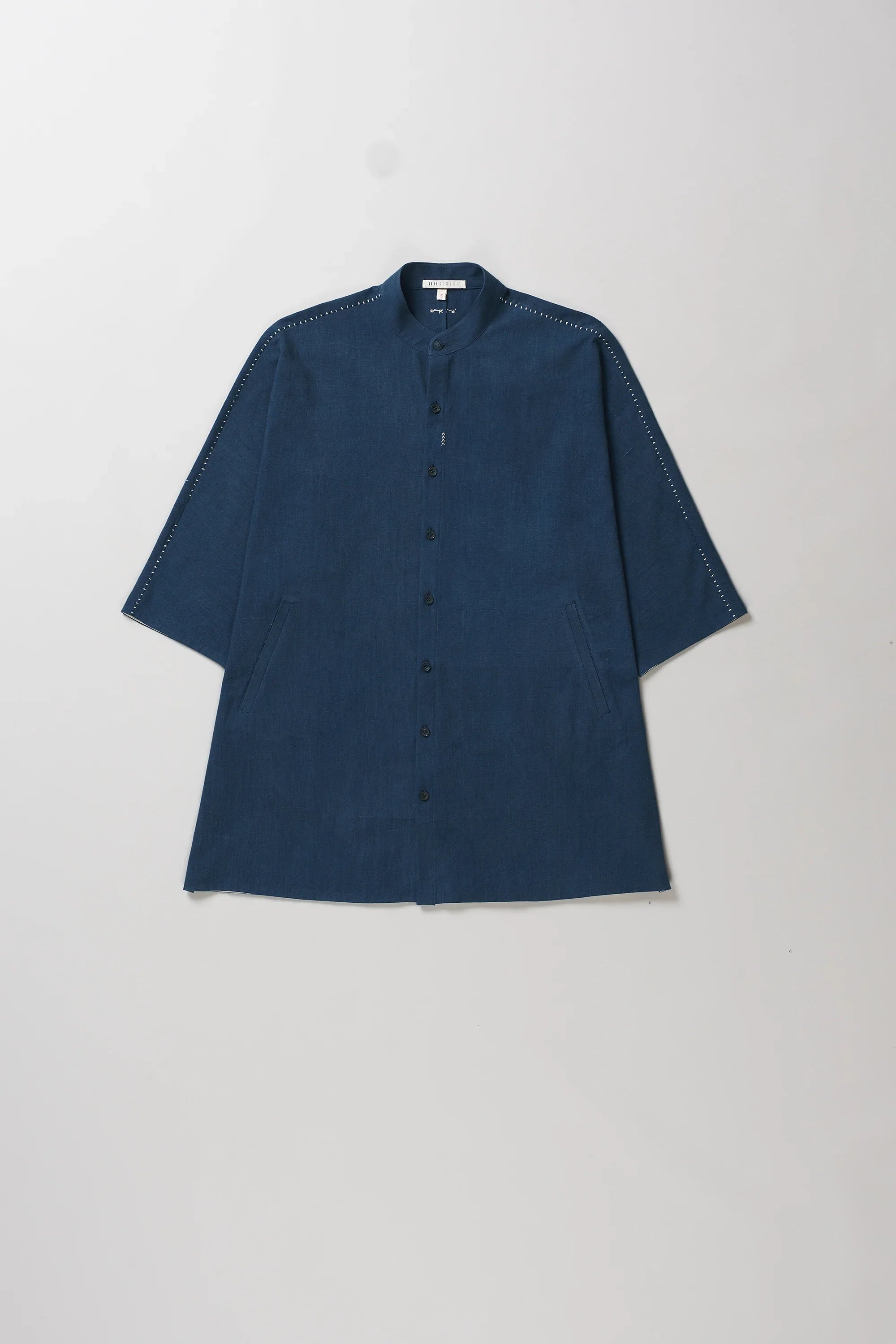 Front image of space blue, short-sleeved button-up shirt with hand details