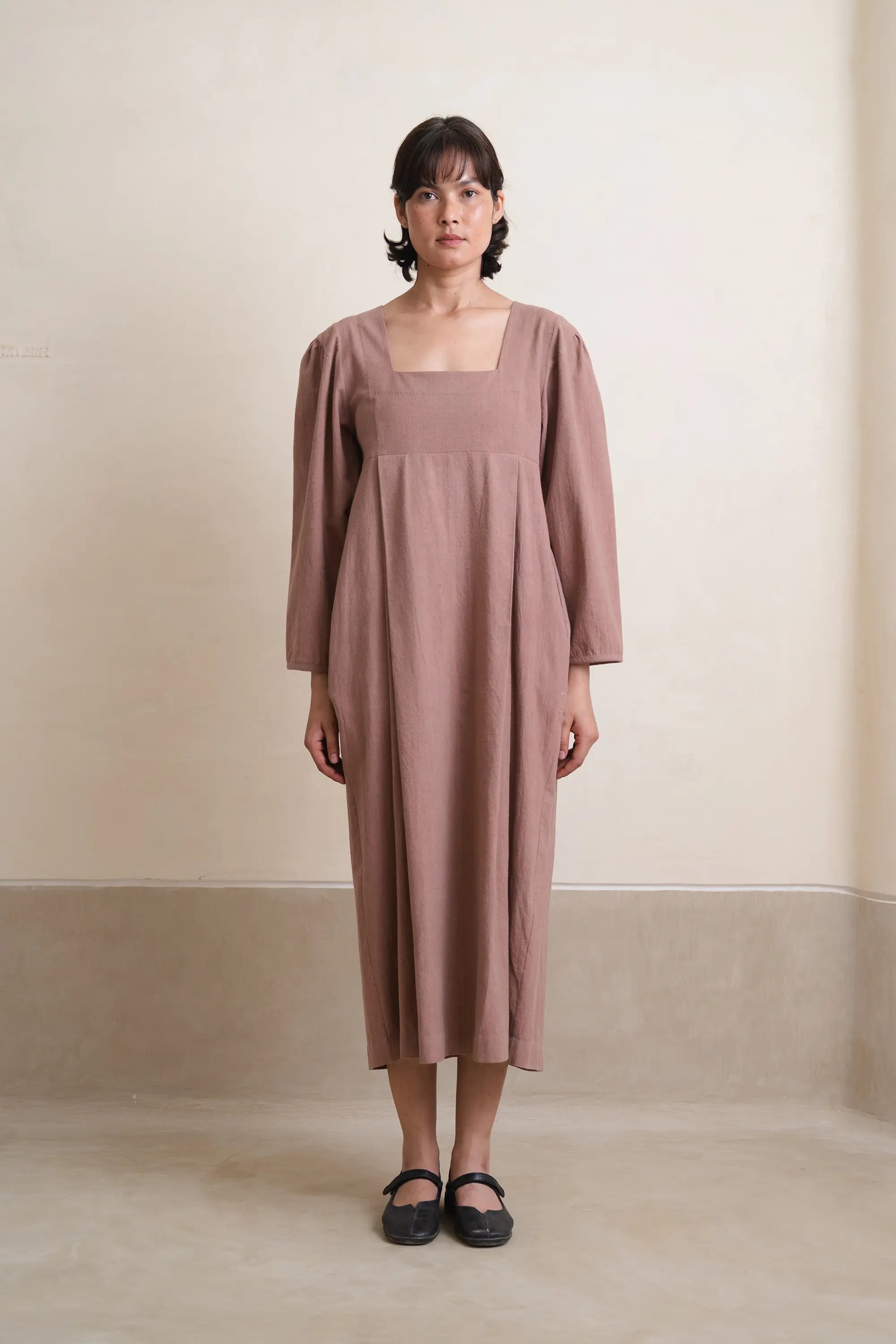 A woman wearing old rose dress