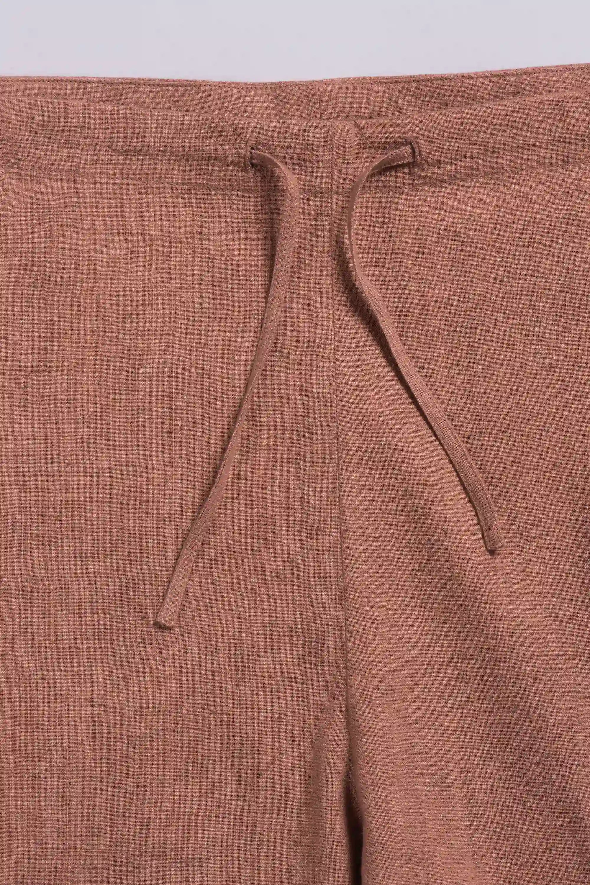 Orange pants with drawstring detail on a light grey background