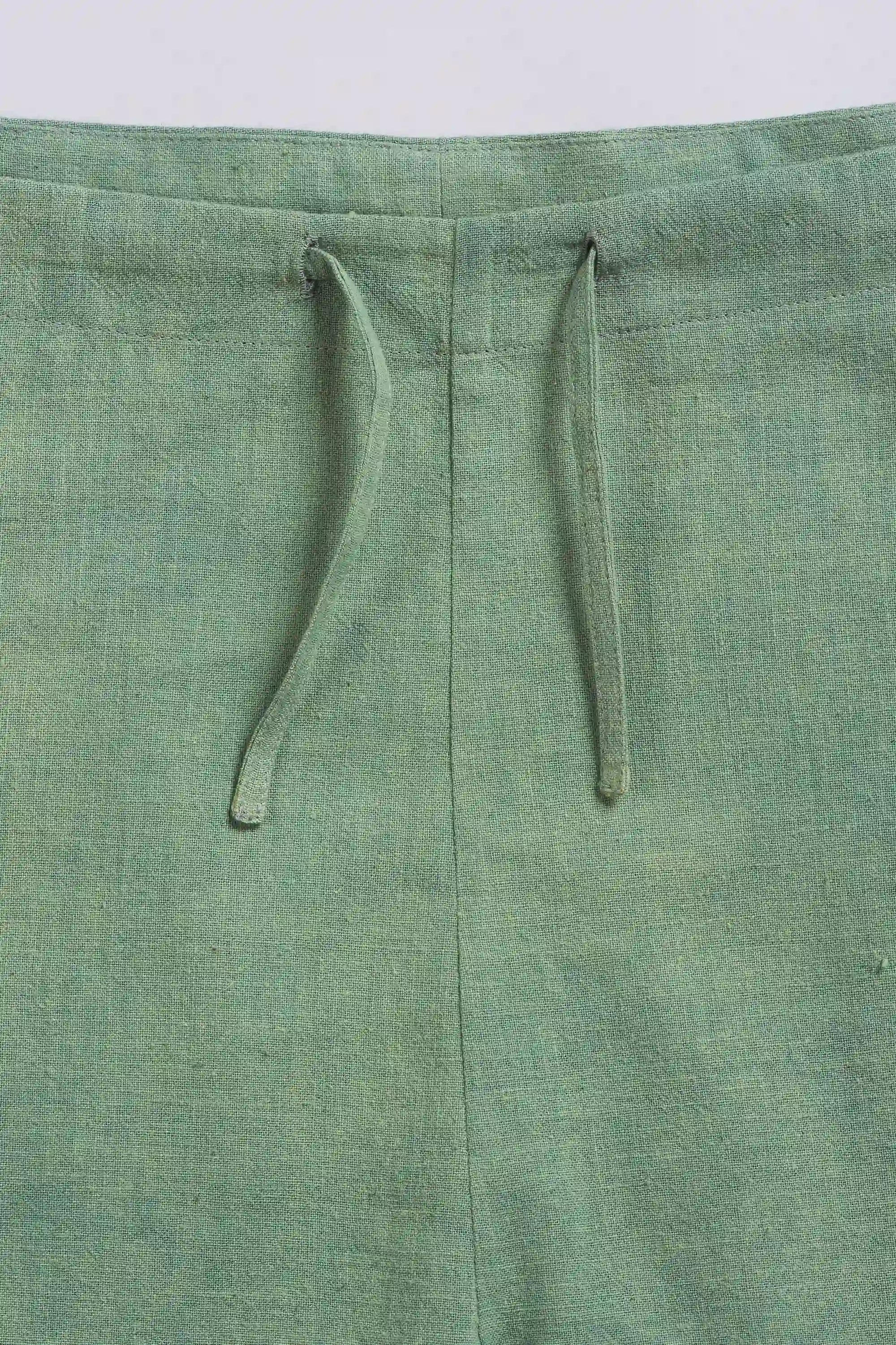 Green fabric with drawstring on a light grey background
