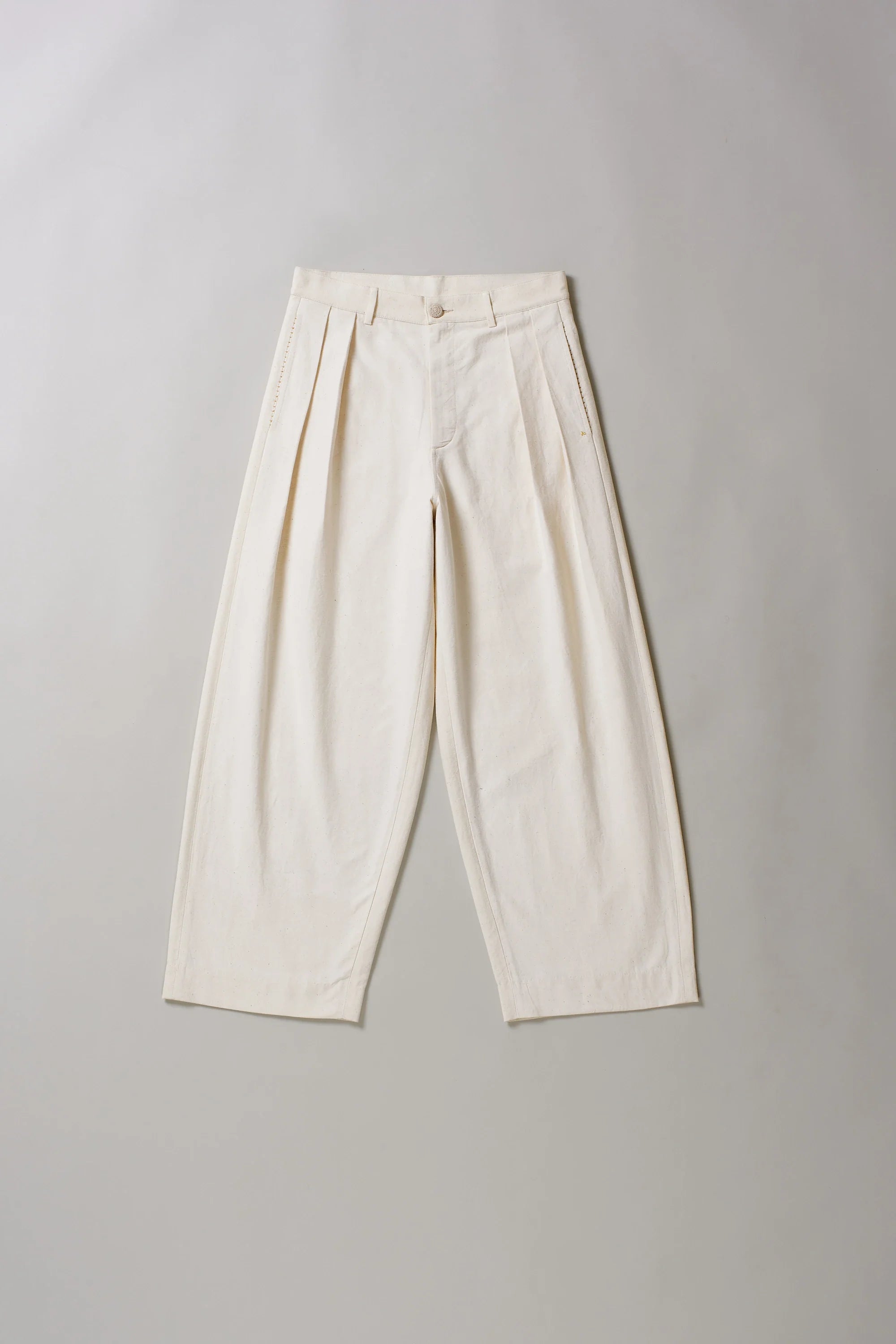 Front image of ecru pants on a grey background