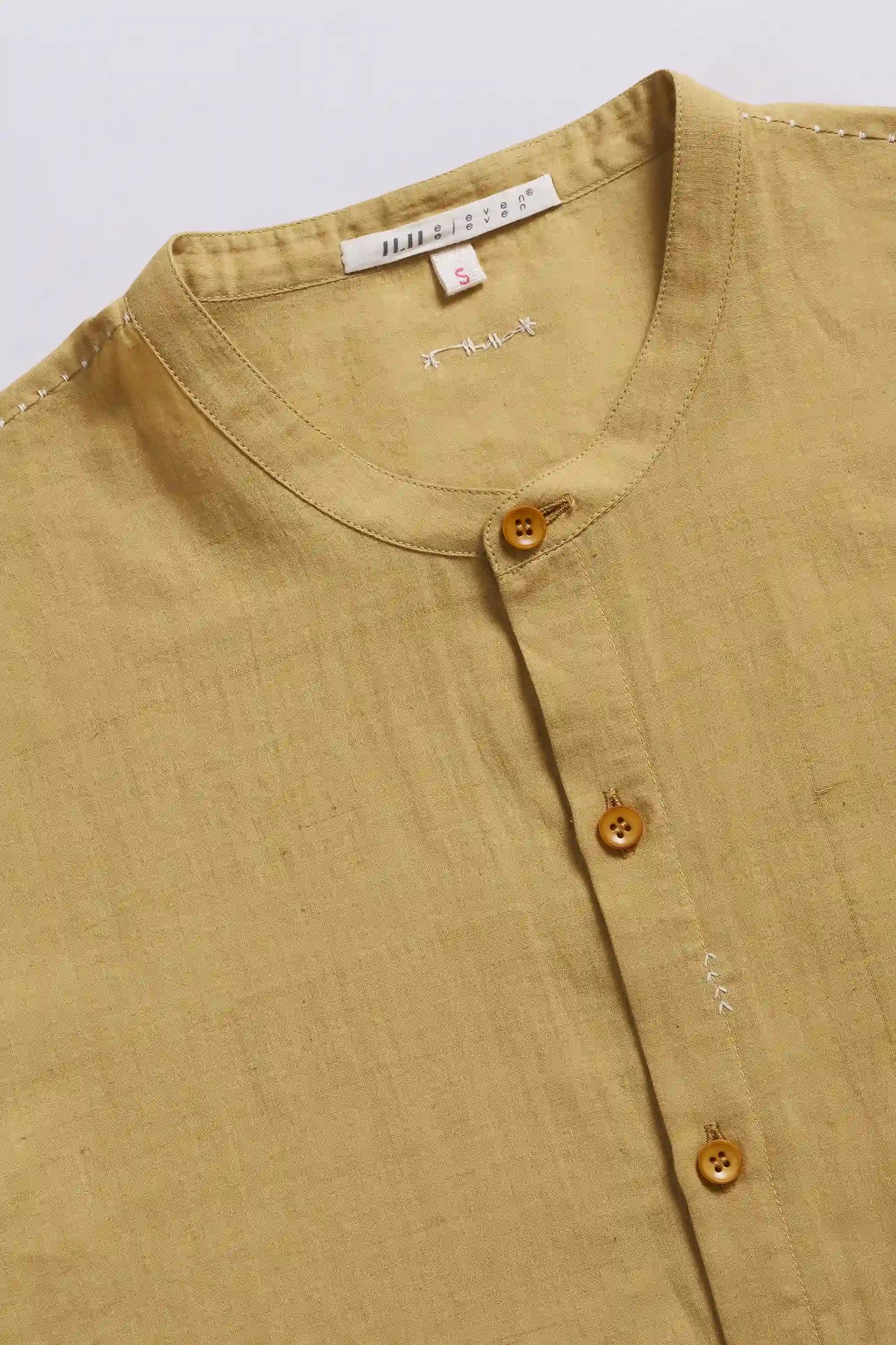 Close-up of a shirt with buttons on a light grey background