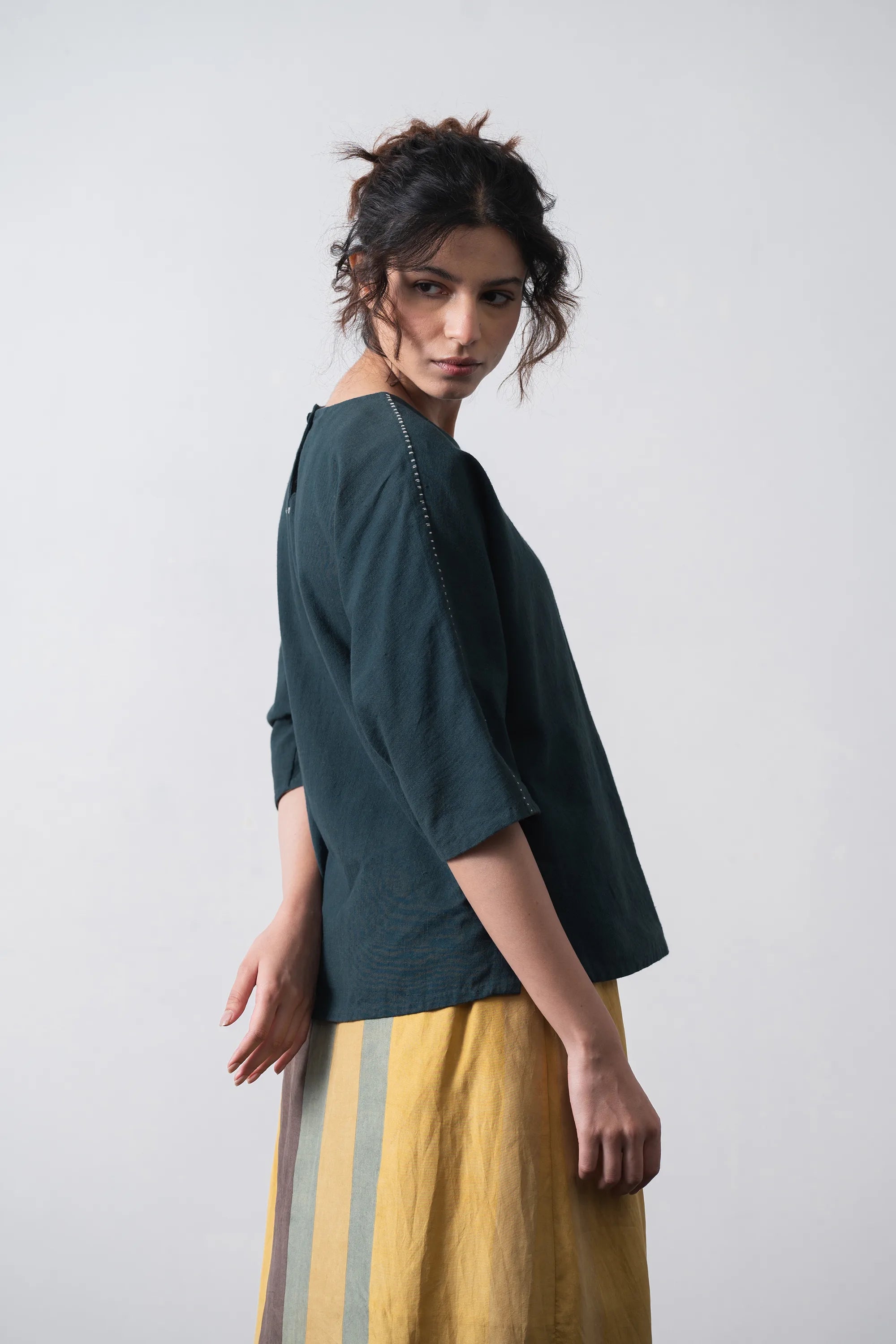 A woman side shot wearing top