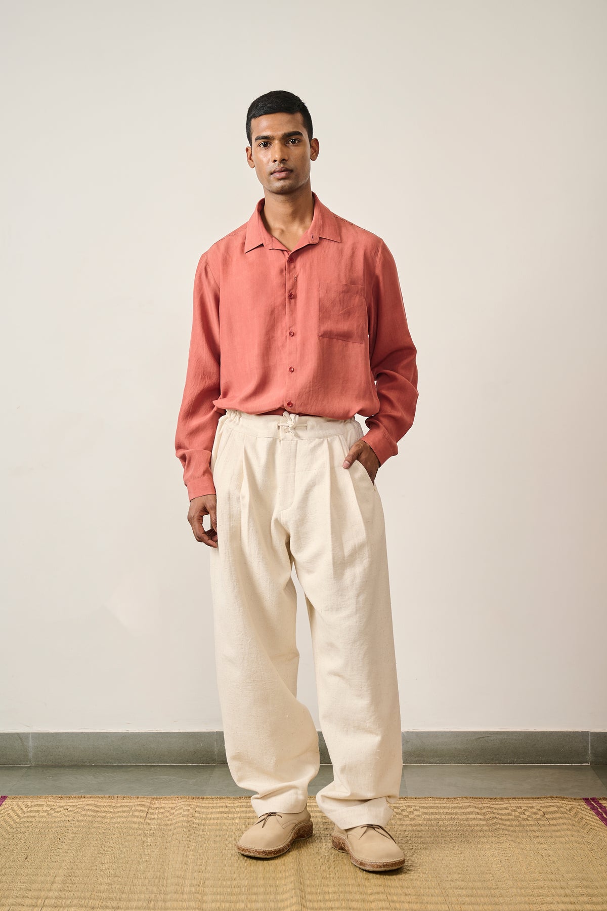 A man wearing ecru cotton trouser