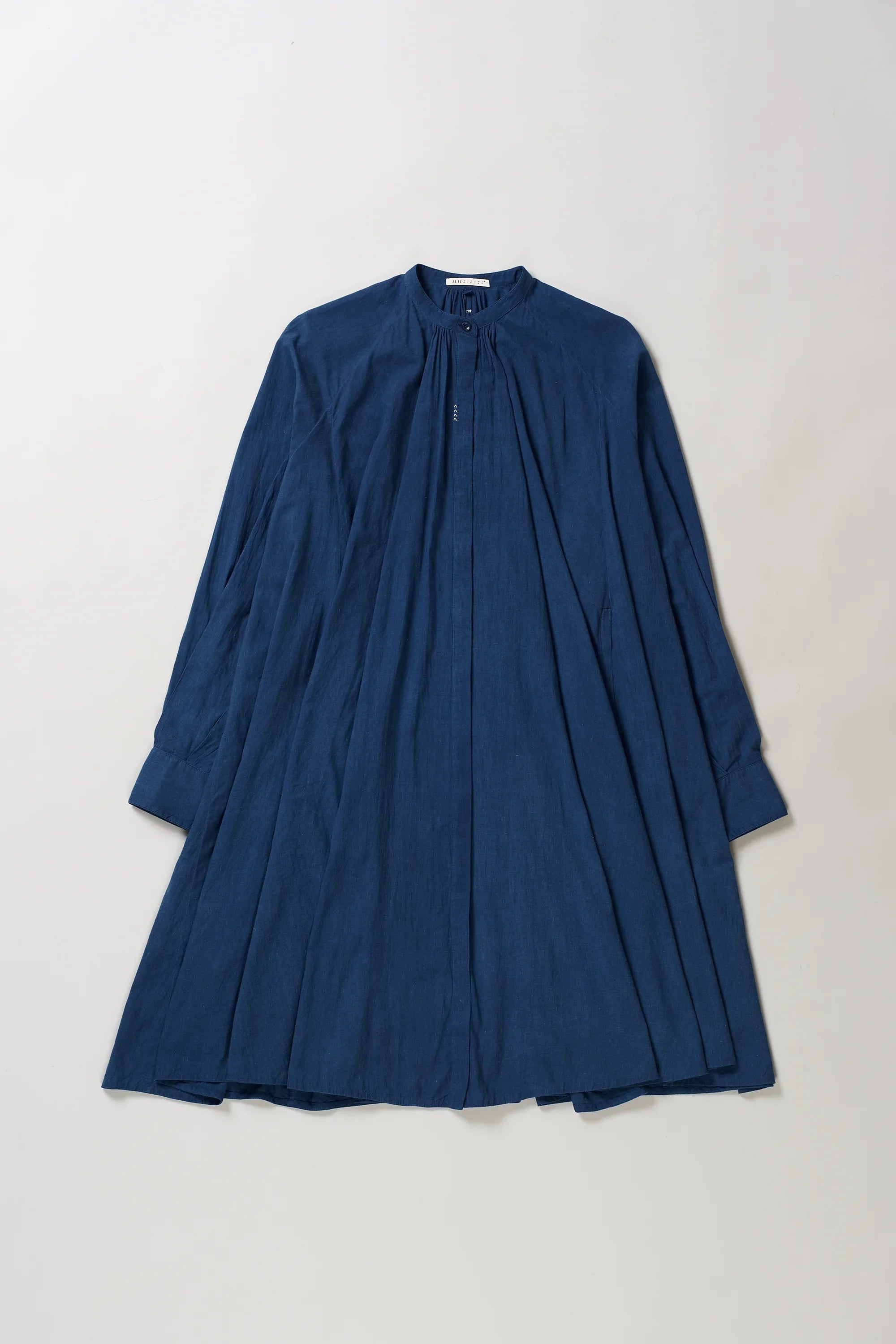 Back image of blue dress on a light grey background