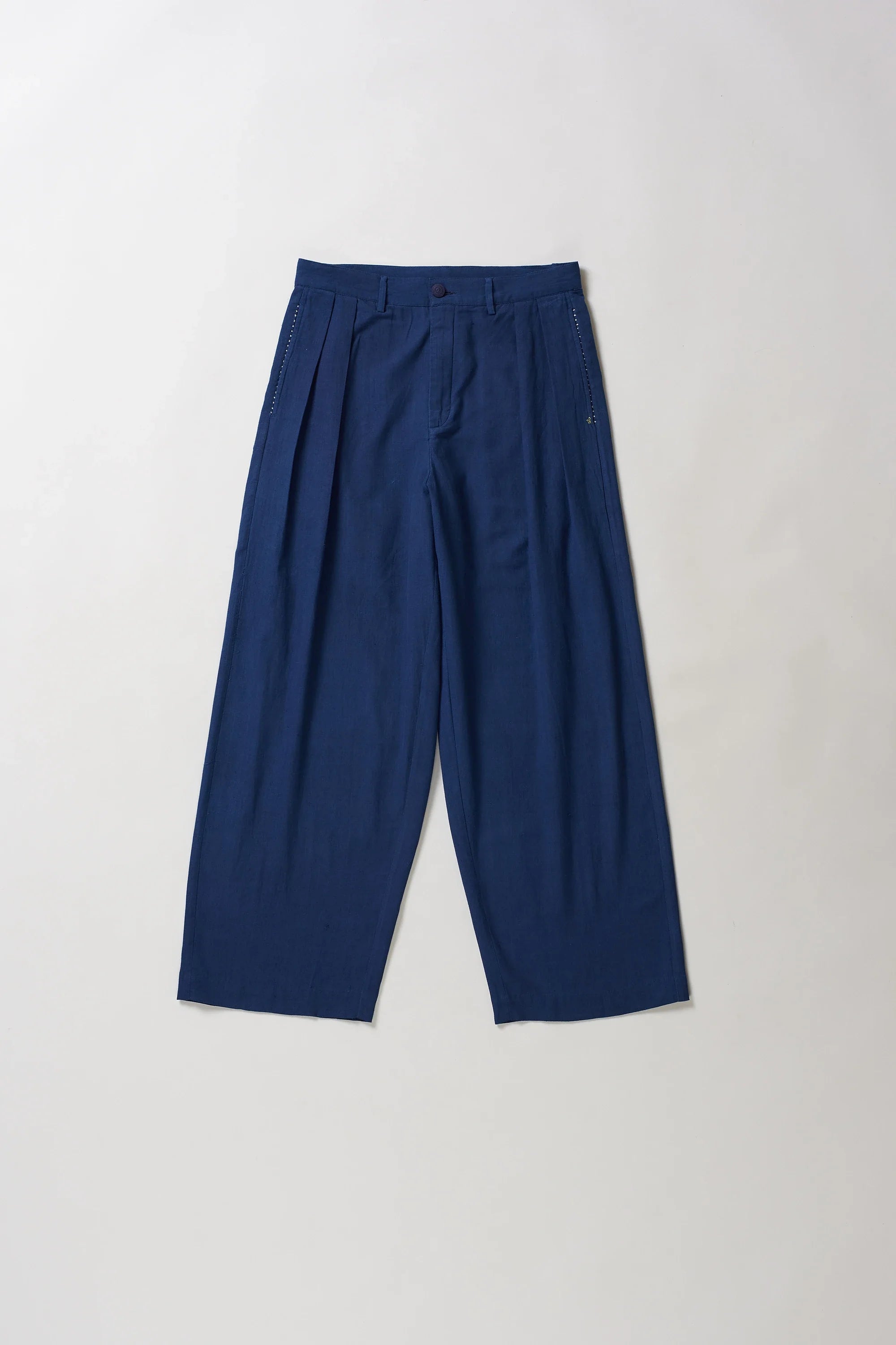 Front image of blue pants with hand detailing on a light grey background