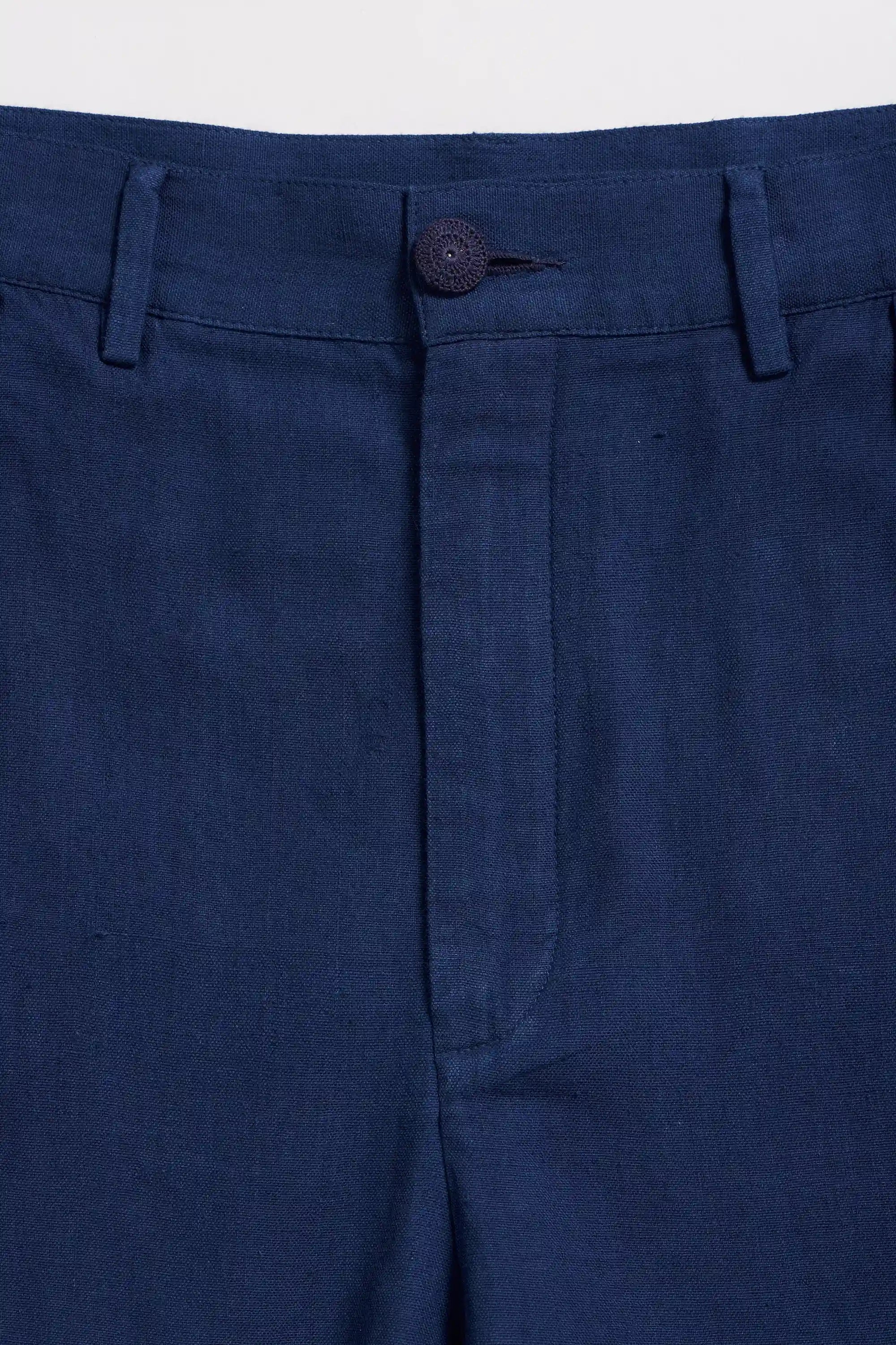 Close-up of a blue fabric with a button on a light grey background