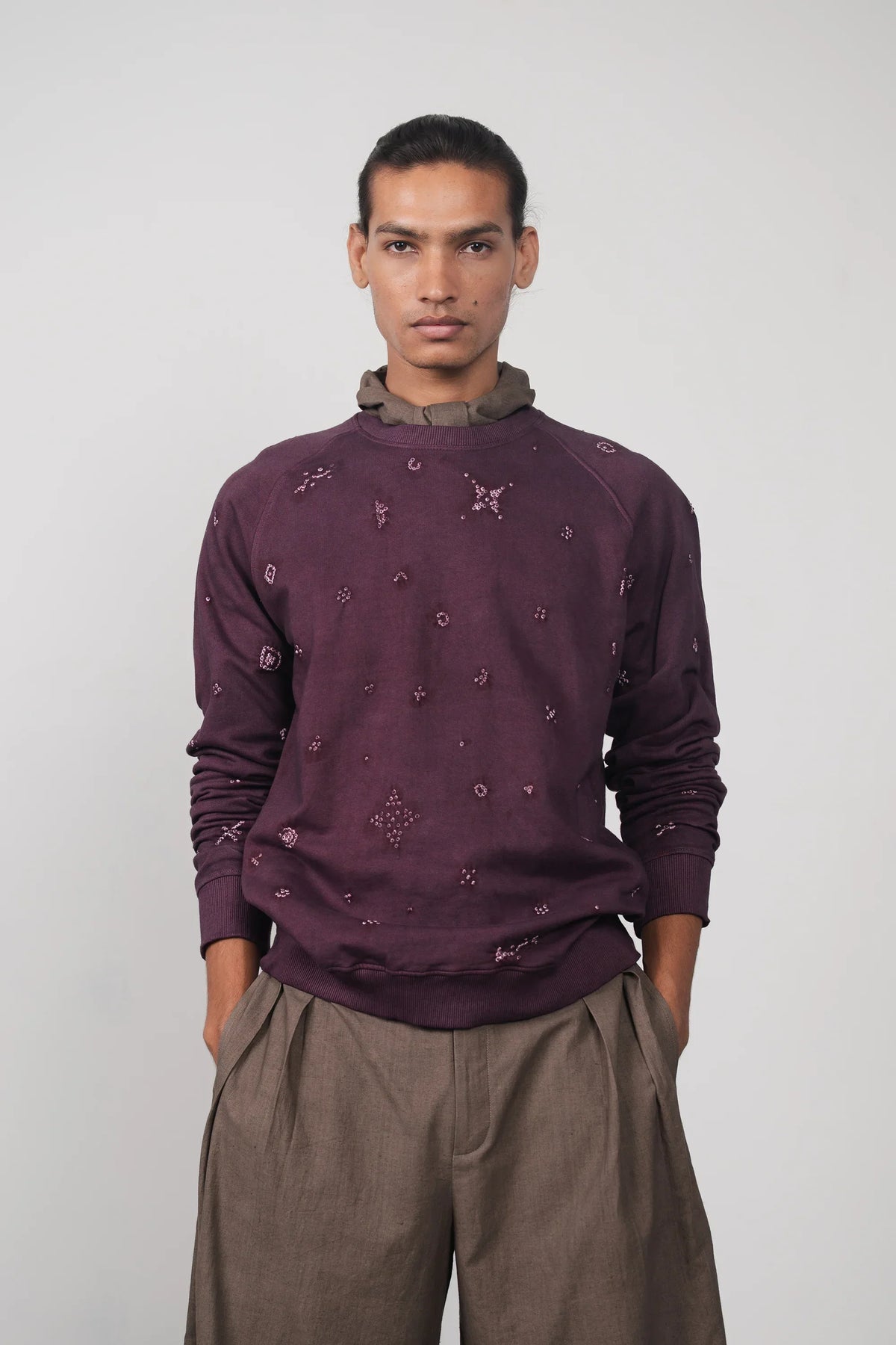 A man wearing purple red sweatshirt