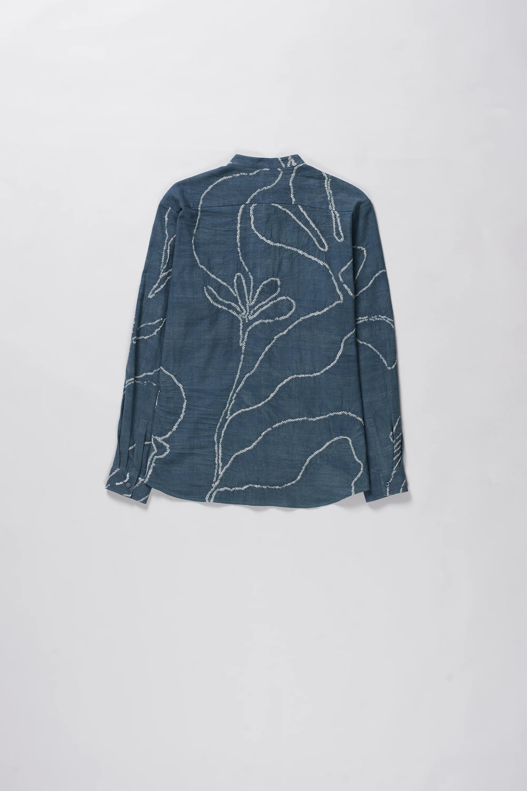 Ash indigo shirt with bandhani on a light grey background