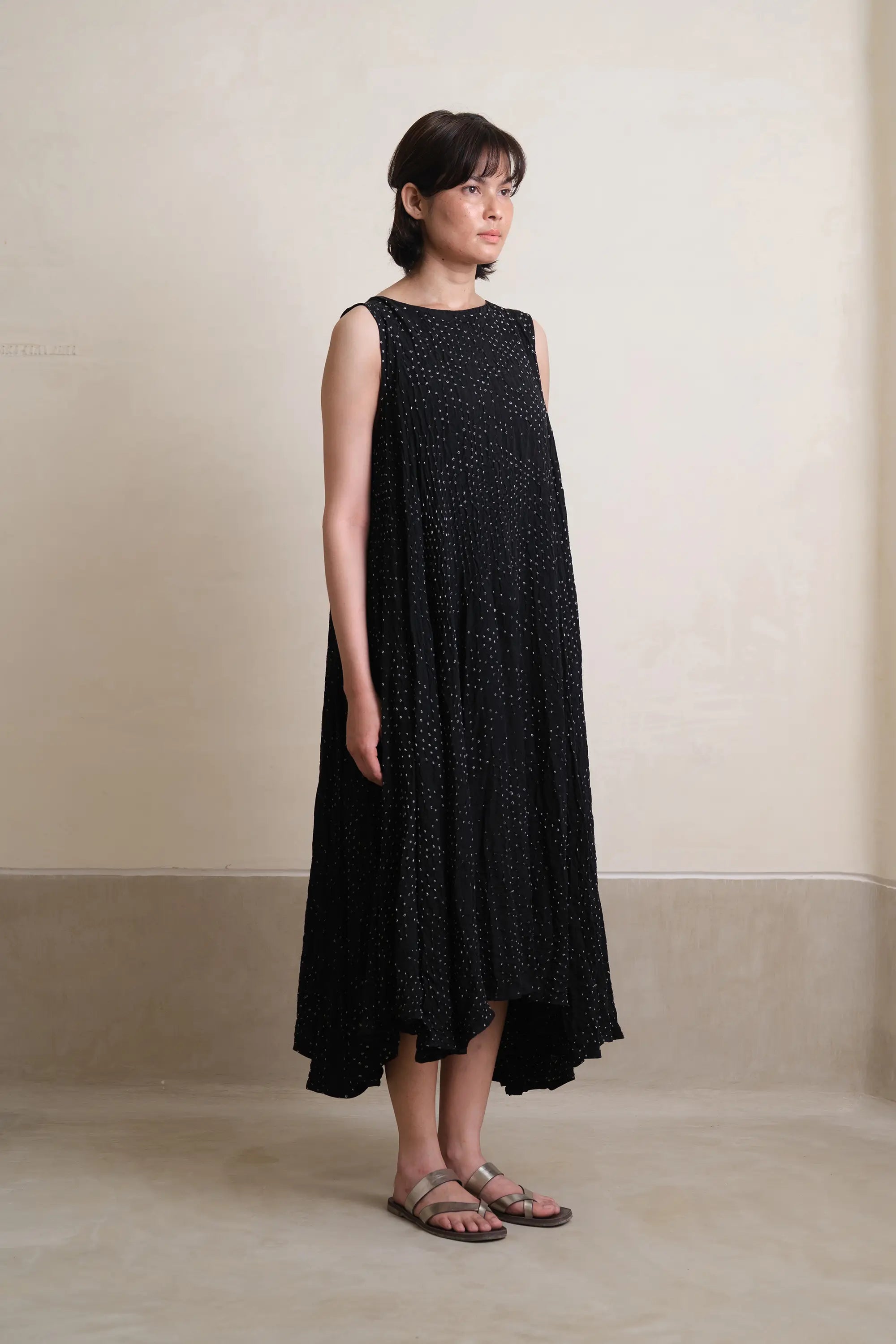 A side shot of a woman wearing black dress