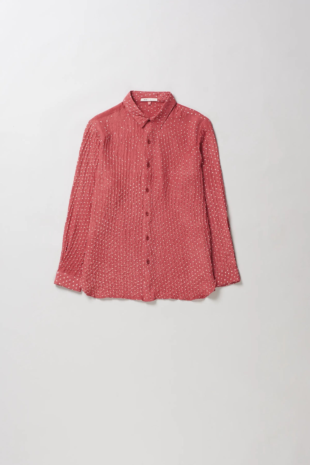 A long-sleeve button-up shirt in a pink hood color with a small bandhani, displayed flat against a light grey background.